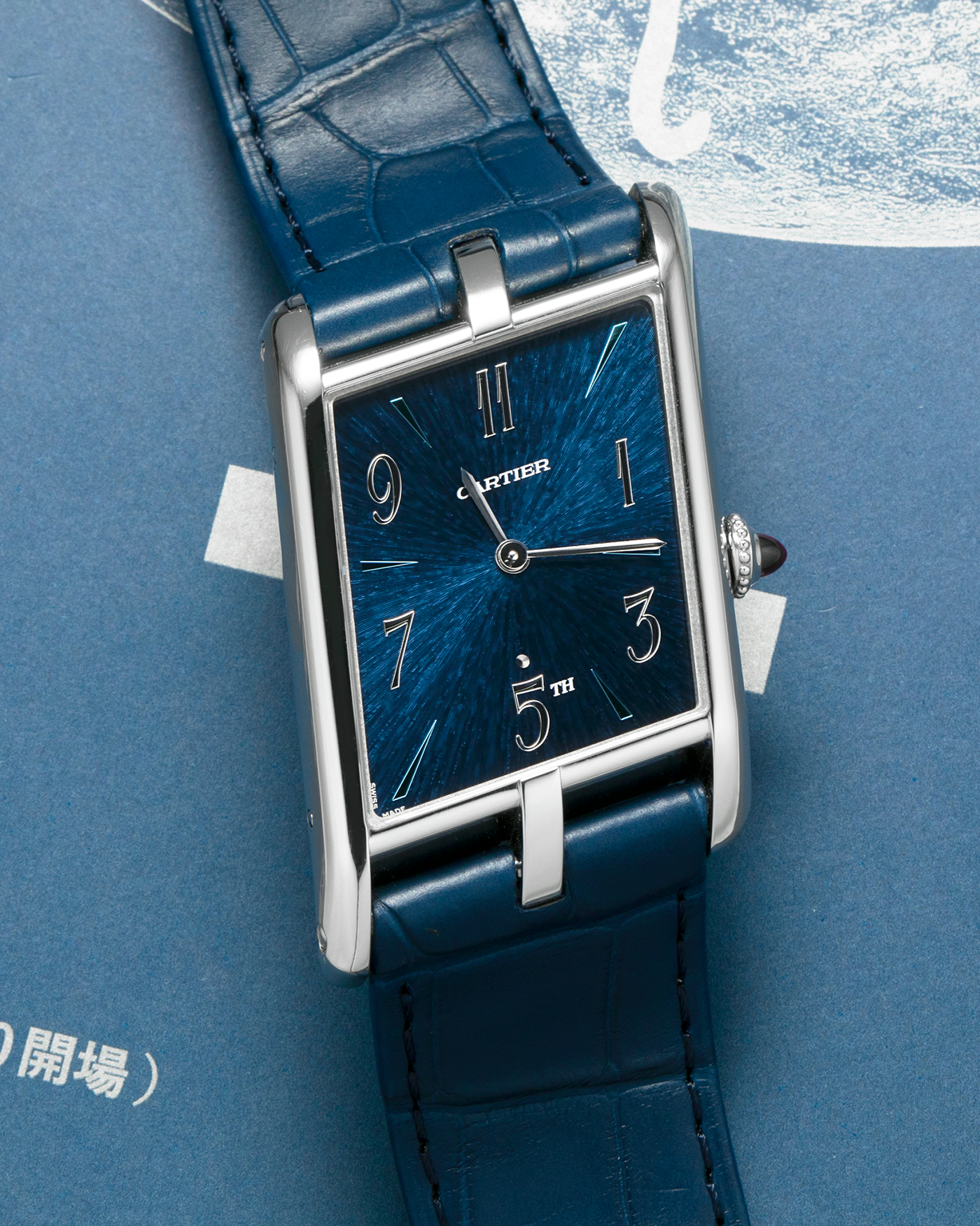 Brand: Cartier
Year: 2024
Model: Privé Tank Asymétrique 5th Ave New York Edition
Reference: WGTA0120
Material:  Platinum 950
Movement: Cartier Cal. 1917MC, Manual-Winding
Case Dimensions: 47mm x 26mm x 6.4mm (44.5mm Lug-to-Lug)
Strap: Cartier Blue Alligator Leather Strap with Signed Platinum 950 Tang Buckle