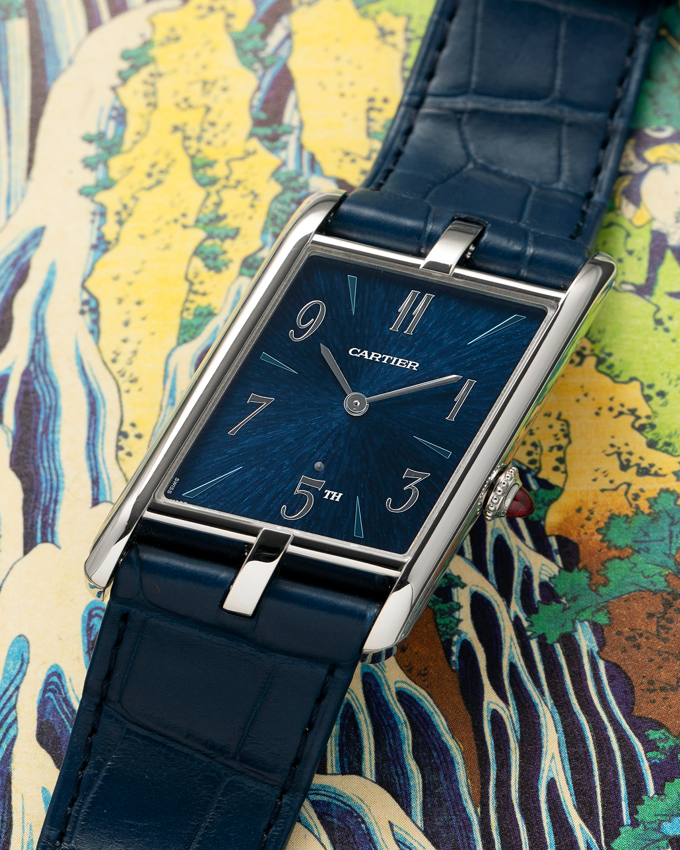 Brand: Cartier
Year: 2024
Model: Privé Tank Asymétrique 5th Ave New York Edition
Reference: WGTA0120
Material:  Platinum 950
Movement: Cartier Cal. 1917MC, Manual-Winding
Case Dimensions: 47mm x 26mm x 6.4mm (44.5mm Lug-to-Lug)
Strap: Cartier Blue Alligator Leather Strap with Signed Platinum 950 Tang Buckle