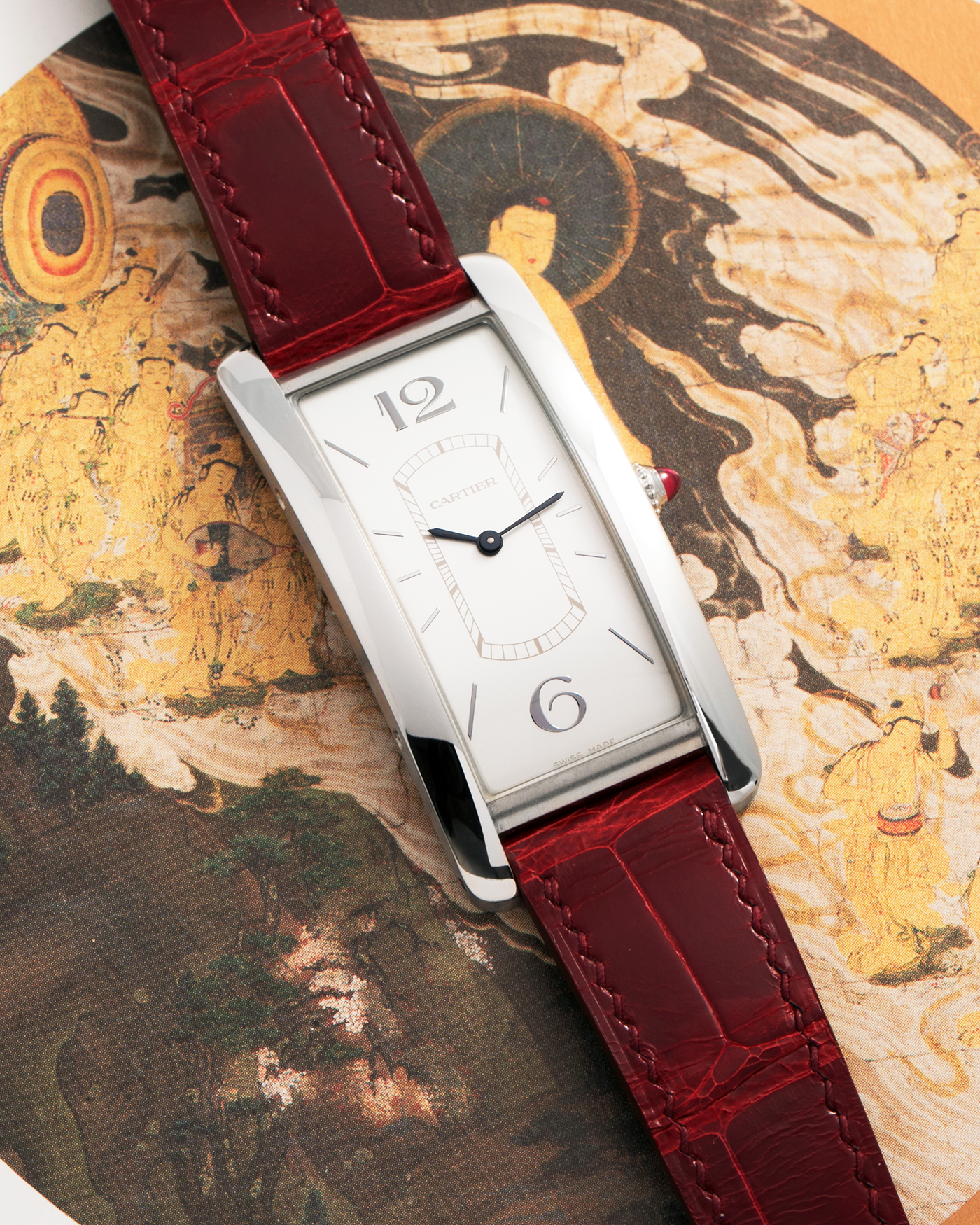 Brand: Cartier
Year: 2018
Model: Privé Tank Cintrée, Limited Edition of 100 pieces (Platinum Variant)
Reference: WGTA0027
Material: Platinum 950
Movement: Cartier Cal. 8971 MC (Based on JLC Cal. 846), Manual-Winding
Case Diameter: 46.3mm x 23 mm (7.1mm Thick)
Lug Width: 16mm
Strap: Cartier Semi-Matt Grey Alligator Leather Strap with Signed Platinum Tang Buckle, Unbranded, Custom Order Red Alligator Strap