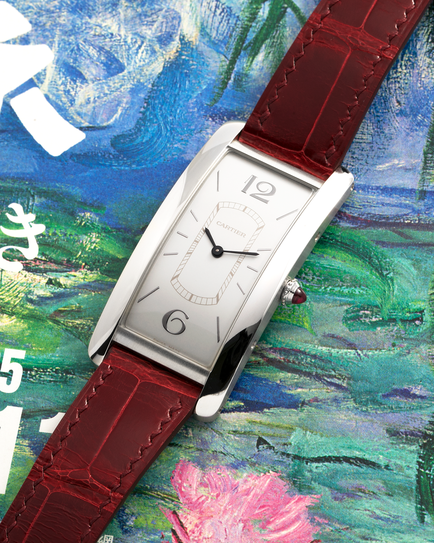 Brand: Cartier
Year: 2018
Model: Privé Tank Cintrée, Limited Edition of 100 pieces (Platinum Variant)
Reference: WGTA0027
Material: Platinum 950
Movement: Cartier Cal. 8971 MC (Based on JLC Cal. 846), Manual-Winding
Case Diameter: 46.3mm x 23 mm (7.1mm Thick)
Lug Width: 16mm
Strap: Cartier Semi-Matt Grey Alligator Leather Strap with Signed Platinum Tang Buckle, Unbranded, Custom Order Red Alligator Strap
