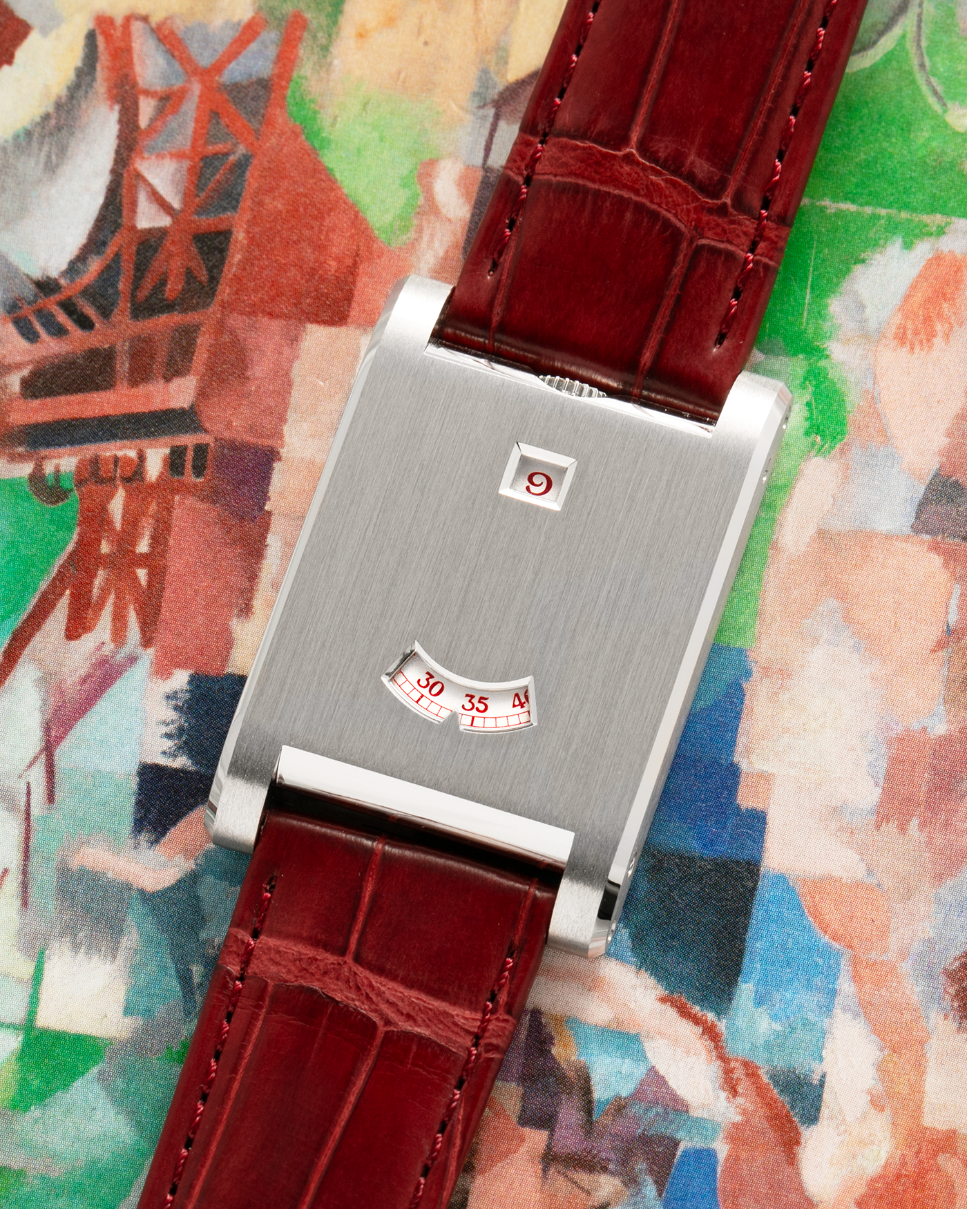 Brand: Cartier
Year: 2026
Model: Privé Tank à Guichets
Reference Number: 4124
Model Number: WGTA0027
Material: Platinum
Movement: Cartier Cal. 9755 MC (Based on Piaget Cal. 430P), Manual-Winding
Case Dimensions: 37.6mm Length 24.8mm Width 6mm Thickness
Lug Width: 18mm
Strap: Cartier Burgundy Alligator Leather Strap with Signed Platinum Tang Buckle

