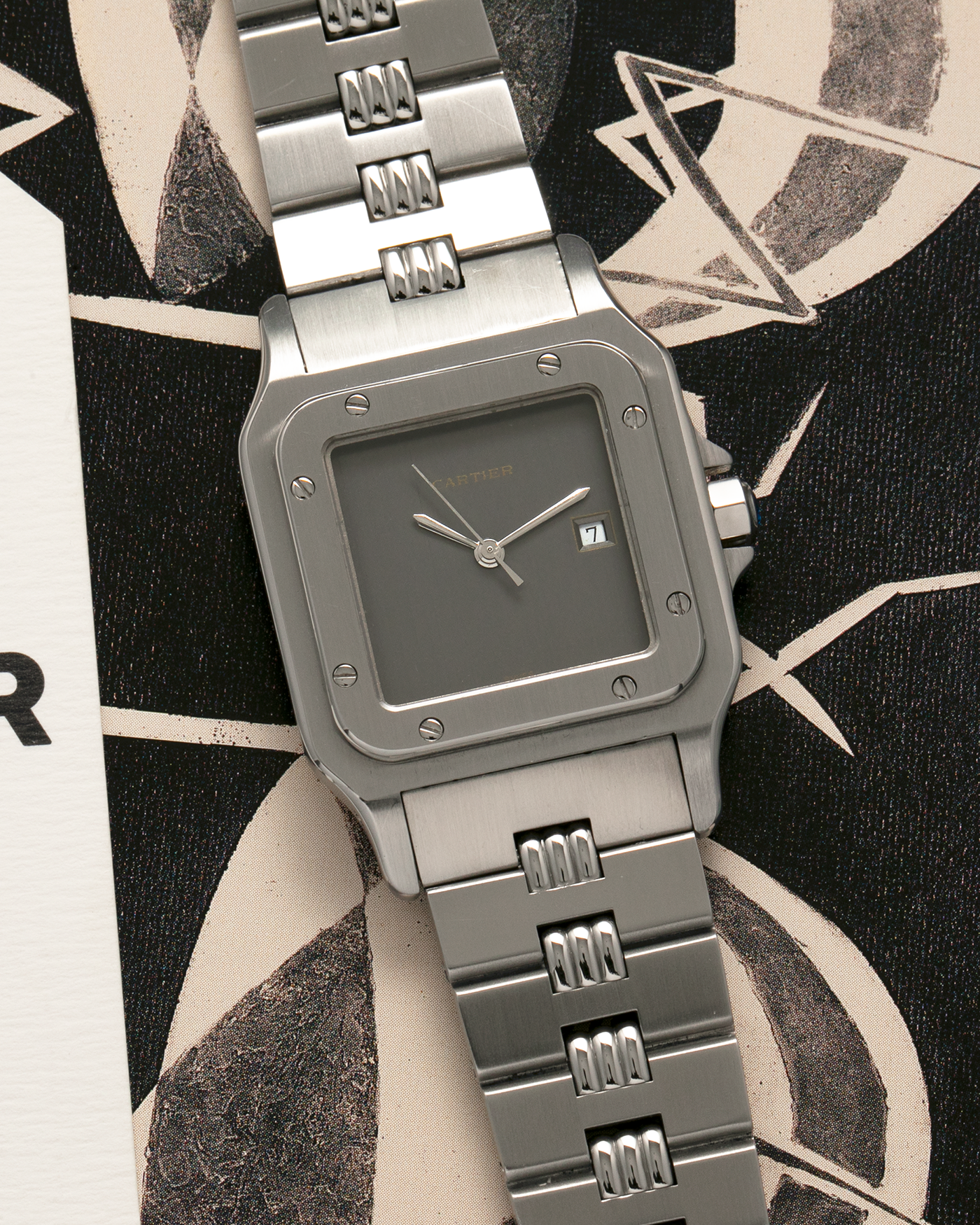 Brand: Cartier Year: 1980s Model: Santos ‘Carrée’ Reference: 2960 Material: Stainless Steel Movement: Cartier Cal. 077 (ETA Cal. 3671 Based), Self-Winding Case Dimensions: 29mm x 40.5mm Lug Width: 18mm Strap: Cartier Stainless Steel Godron ‘541811’ Bracelet with Signed Clasp