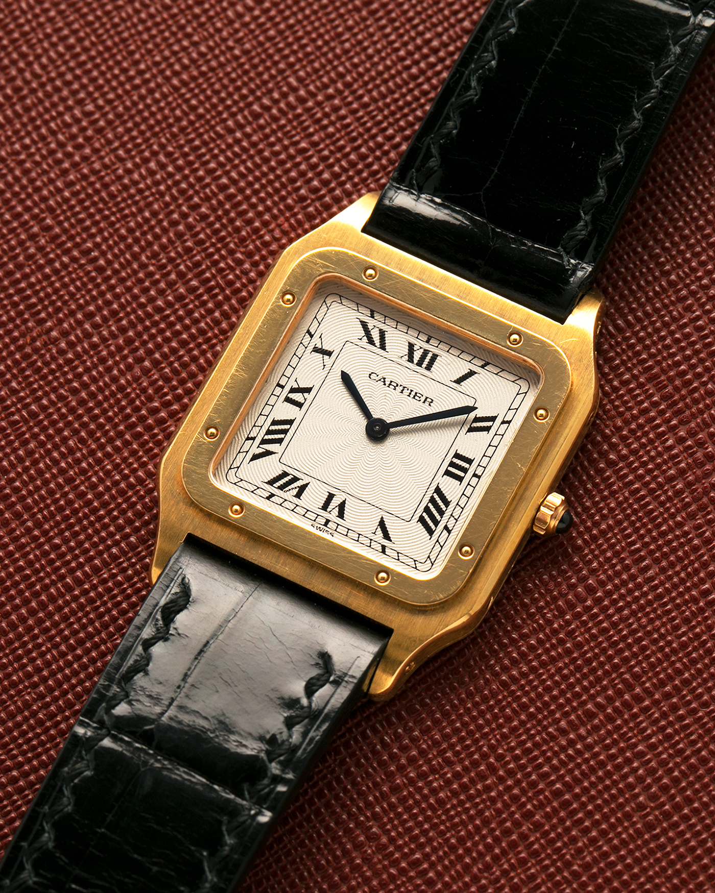Brand: Cartier
Year: 1990s
Model: Santos Dumont
Reference: 1576
Material: 18-carat Yellow Gold
Movement: Cartier Cal. 021MC (Based on Frédéric Piguet 21 ébauche), Manual-Winding
Case Dimensions: 27mm x 6.5mm (Lug-to-Lug 36mm)
Lug Width: 17mm
Strap: Generic Unnamed Black Calf Leather Strap with Cartier Style Gold Plated Tang Buckle, Cartier Black Alligator Leather Strap
