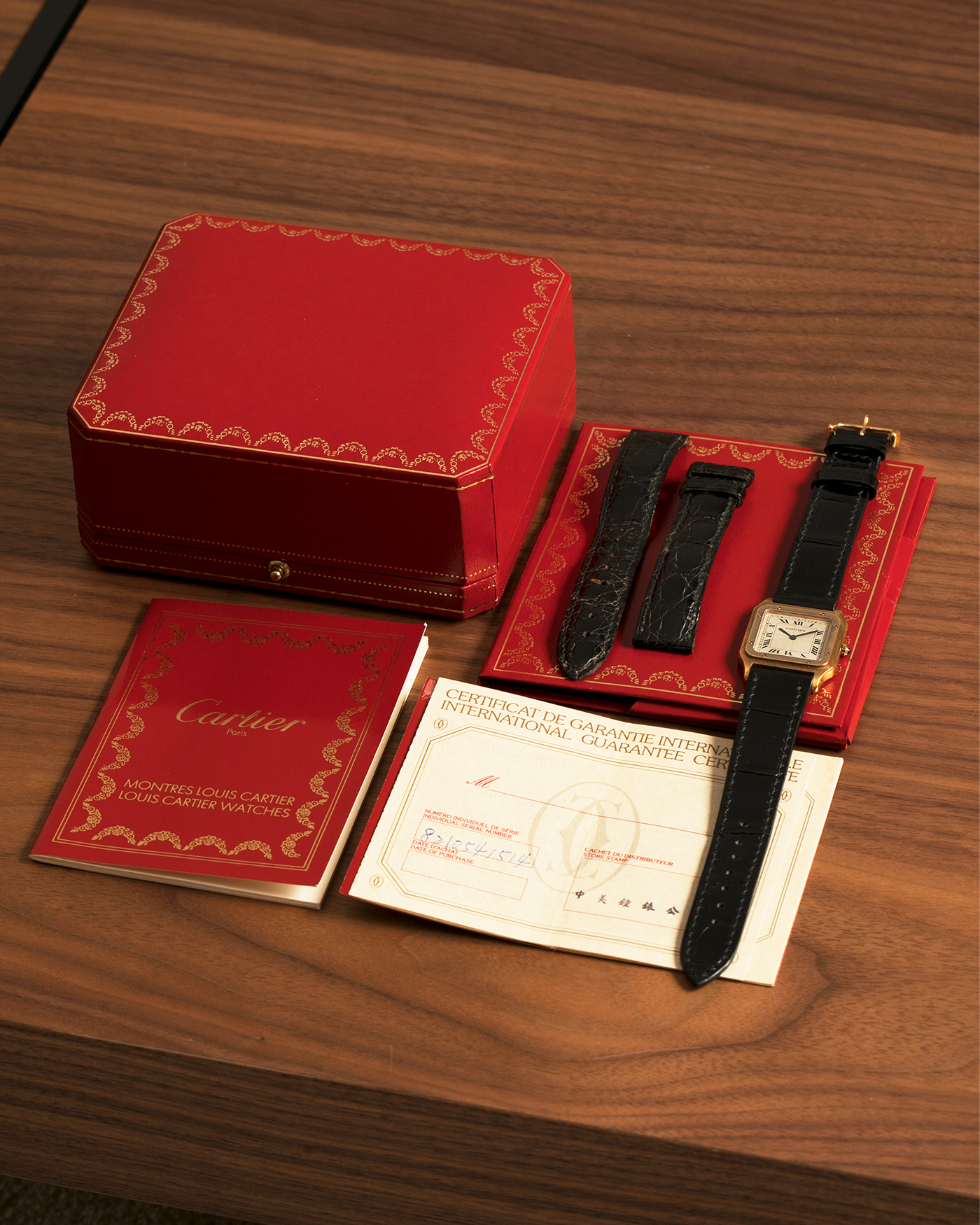 Brand: Cartier
Year: 1990s
Model: Santos Dumont
Reference: 1576
Material: 18-carat Yellow Gold
Movement: Cartier Cal. 021MC (Based on Frédéric Piguet 21 ébauche), Manual-Winding
Case Dimensions: 27mm x 6.5mm (Lug-to-Lug 36mm)
Lug Width: 17mm
Strap: Generic Unnamed Black Calf Leather Strap with Cartier Style Gold Plated Tang Buckle, Cartier Black Alligator Leather Strap