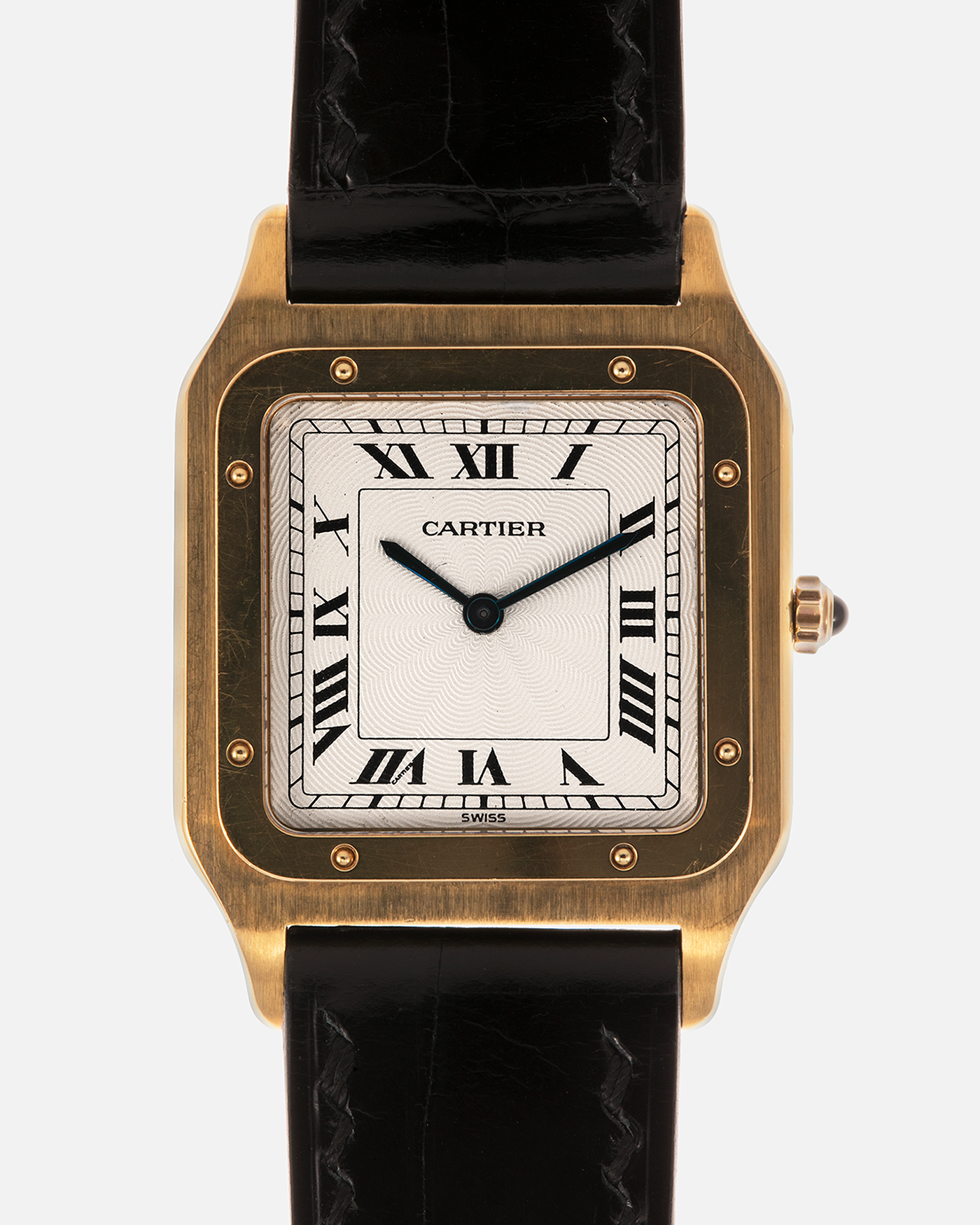 Brand: Cartier
Year: 1990s
Model: Santos Dumont
Reference: 1576
Material: 18-carat Yellow Gold
Movement: Cartier Cal. 021MC (Based on Frédéric Piguet 21 ébauche), Manual-Winding
Case Dimensions: 27mm x 6.5mm (Lug-to-Lug 36mm)
Lug Width: 17mm
Strap: Generic Unnamed Black Calf Leather Strap with Cartier Style Gold Plated Tang Buckle, Cartier Black Alligator Leather Strap