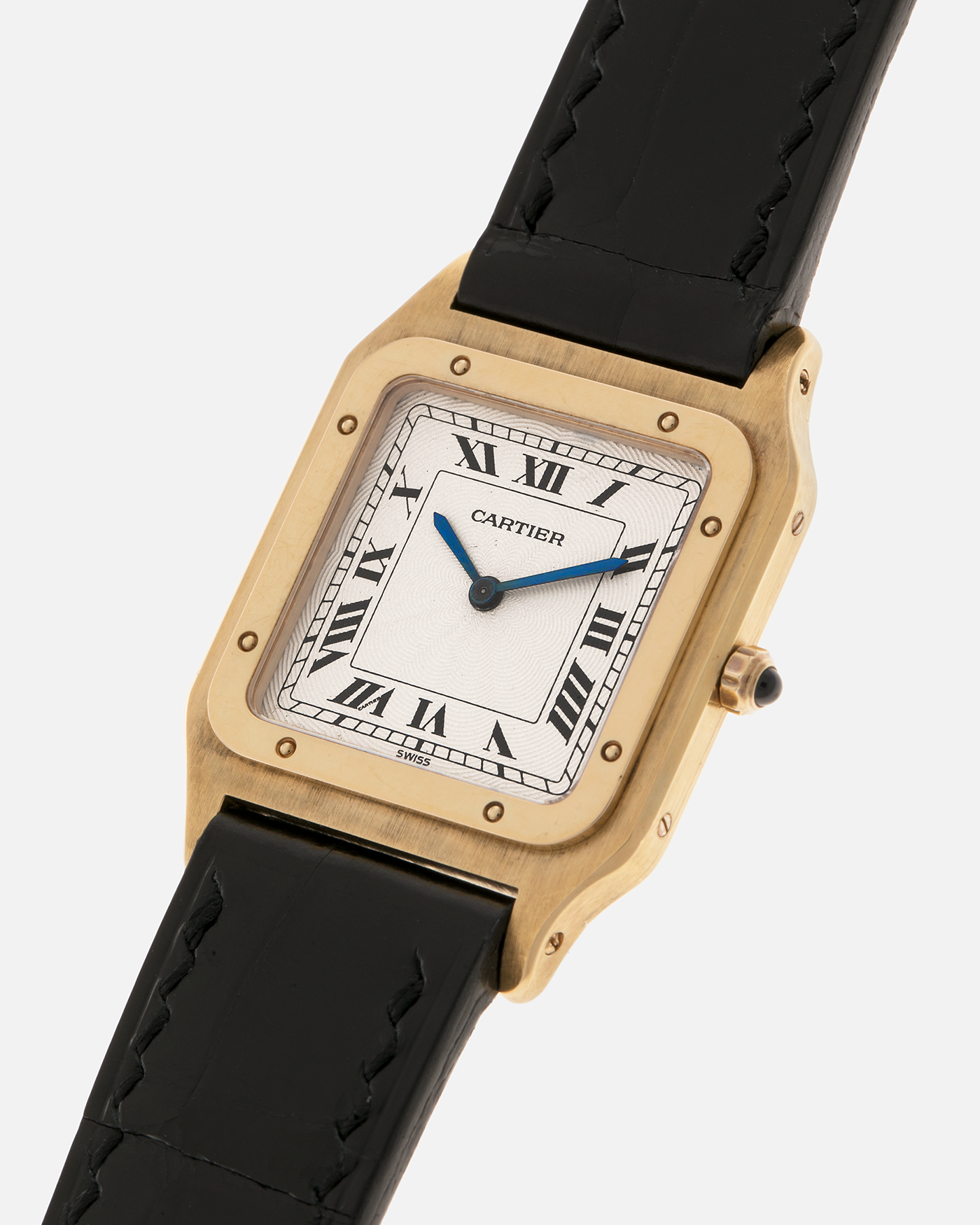 Brand: Cartier
Year: 1990s
Model: Santos Dumont
Reference: 1576
Material: 18-carat Yellow Gold
Movement: Cartier Cal. 021MC (Based on Frédéric Piguet 21 ébauche), Manual-Winding
Case Dimensions: 27mm x 6.5mm (Lug-to-Lug 36mm)
Lug Width: 17mm
Strap: Generic Unnamed Black Calf Leather Strap with Cartier Style Gold Plated Tang Buckle, Cartier Black Alligator Leather Strap