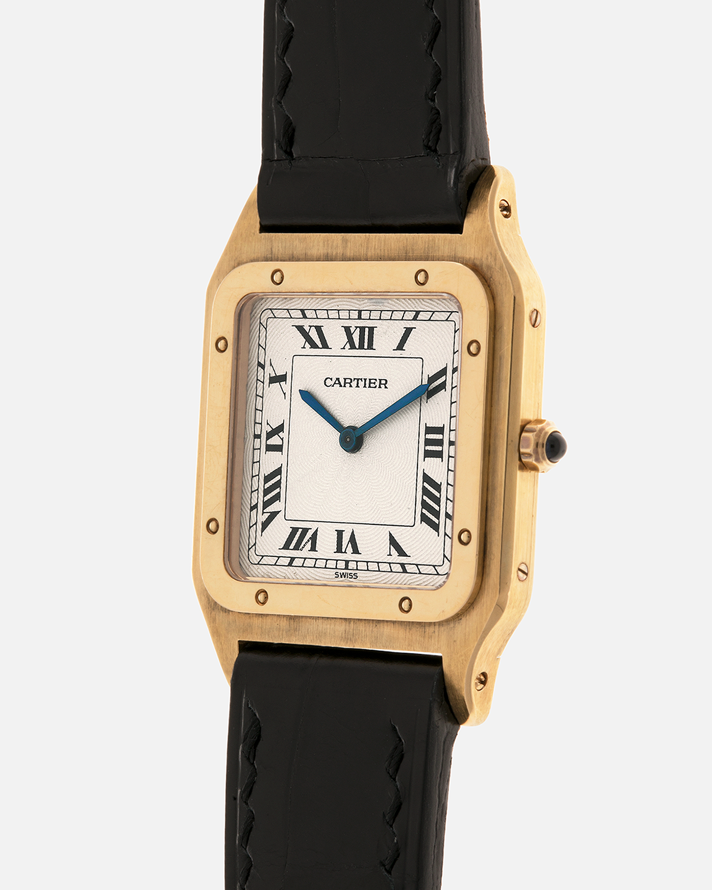 Brand: Cartier
Year: 1990s
Model: Santos Dumont
Reference: 1576
Material: 18-carat Yellow Gold
Movement: Cartier Cal. 021MC (Based on Frédéric Piguet 21 ébauche), Manual-Winding
Case Dimensions: 27mm x 6.5mm (Lug-to-Lug 36mm)
Lug Width: 17mm
Strap: Generic Unnamed Black Calf Leather Strap with Cartier Style Gold Plated Tang Buckle, Cartier Black Alligator Leather Strap