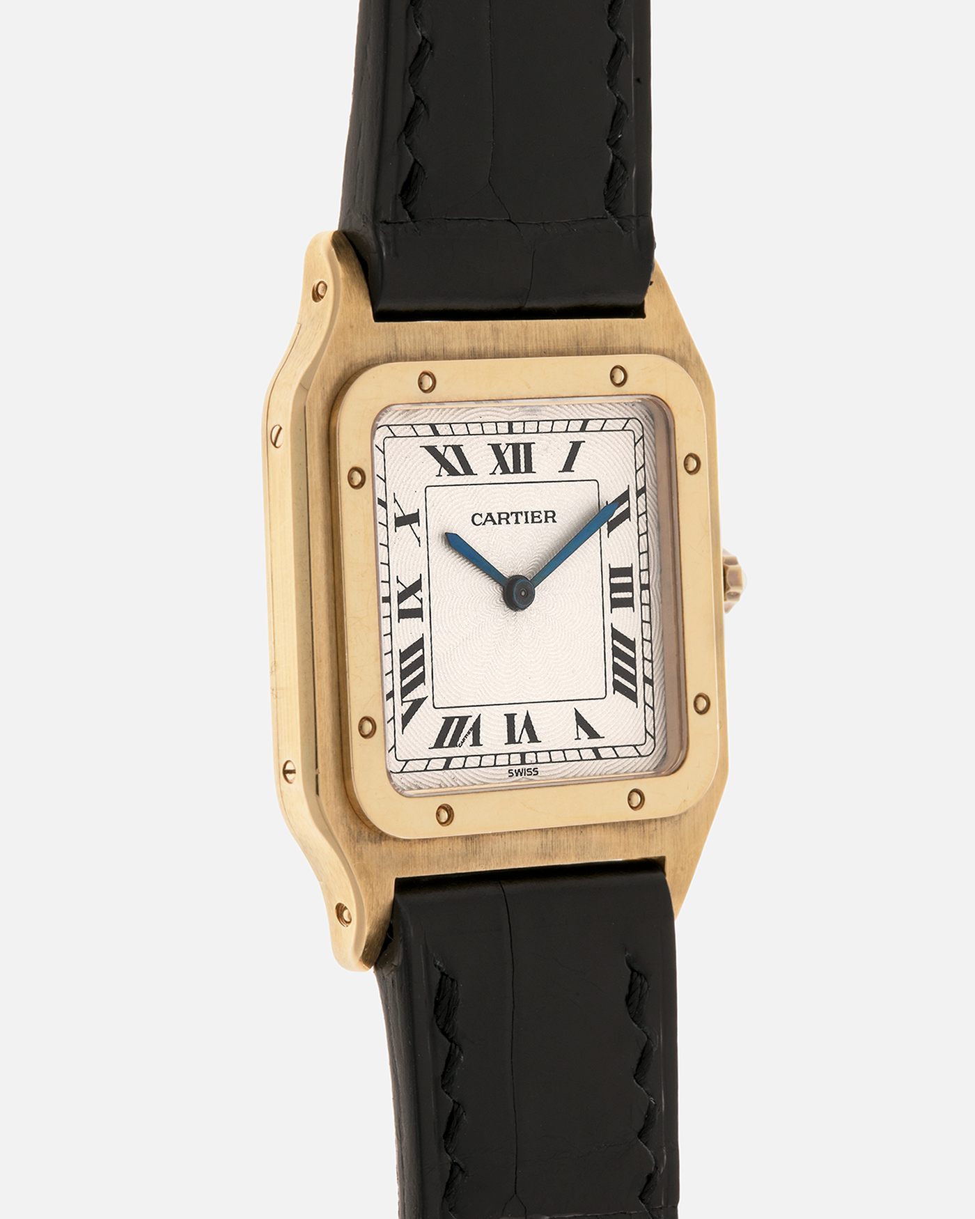 Brand: Cartier
Year: 1990s
Model: Santos Dumont
Reference: 1576
Material: 18-carat Yellow Gold
Movement: Cartier Cal. 021MC (Based on Frédéric Piguet 21 ébauche), Manual-Winding
Case Dimensions: 27mm x 6.5mm (Lug-to-Lug 36mm)
Lug Width: 17mm
Strap: Generic Unnamed Black Calf Leather Strap with Cartier Style Gold Plated Tang Buckle, Cartier Black Alligator Leather Strap