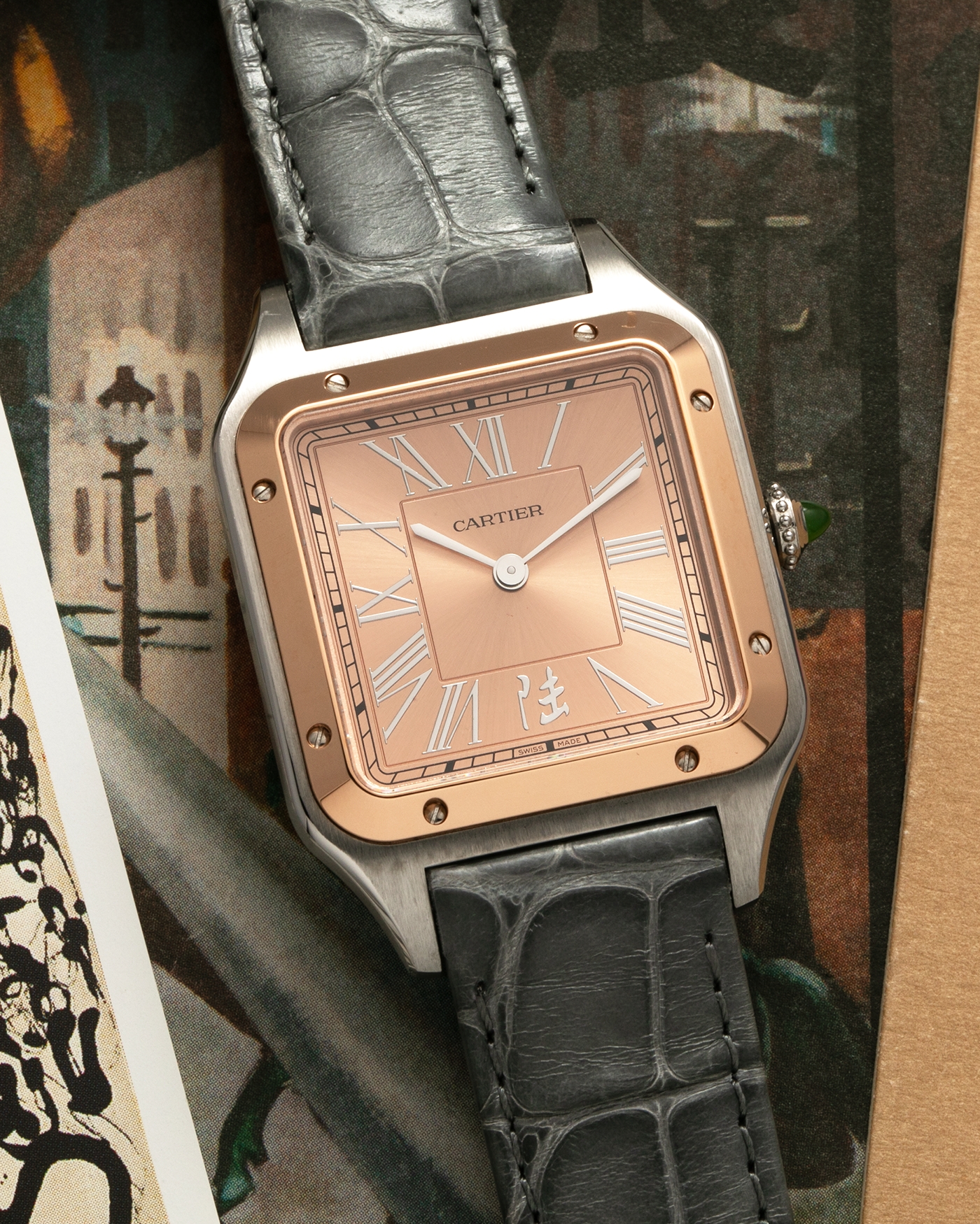 Brand: Cartier Year: 2022 Model: Santos-Dumont ‘China’, Limited Edition of 300 pieces Reference Number: W2SA0027 Material: Stainless Steel Case and 18-carat Rose Gold Bezel Movement: Cartier Cal. 430 MC, Manual-Winding Case Dimensions: 43.5mm x 31.4mm Lud Width: 18mm Strap: Cartier Anthracite Grey Alligator Leather Strap with Signed Stainless Steel Tang Buckle