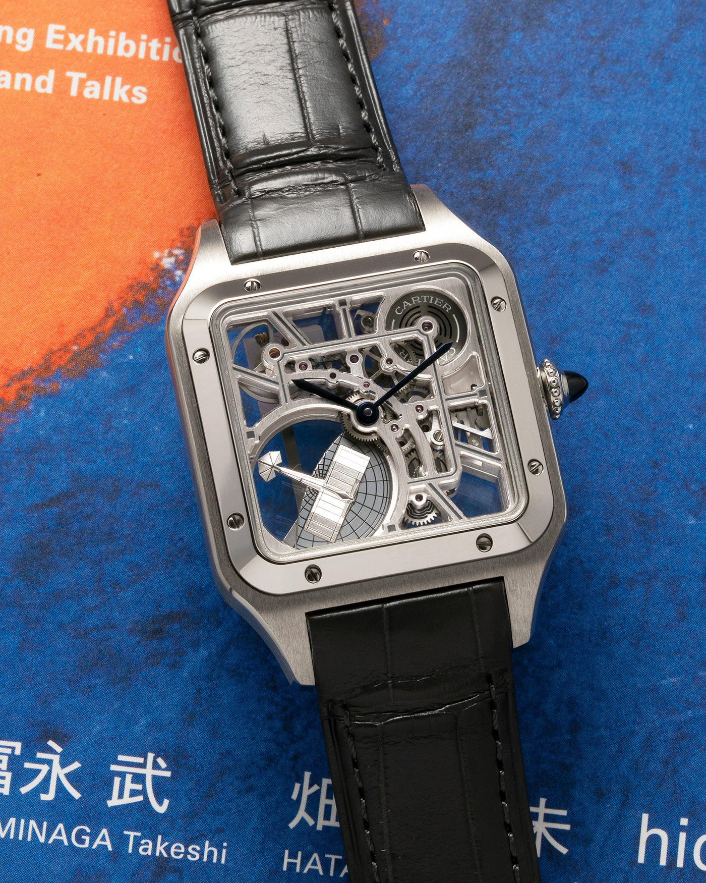 Brand: Cartier Year: 2023 Model: Santos Dumont Skeleton MicroRotor Reference: CRWHSA0032 Material: Stainless Steel Movement: Cartier Cal. 9629 MC, Self-Winding Micro-Rotor Case Diameter: 31.4mm x 43.5mm Strap: Cartier Grey Alligator Leather Strap with Signed Stainless Steel Ardillon Buckle