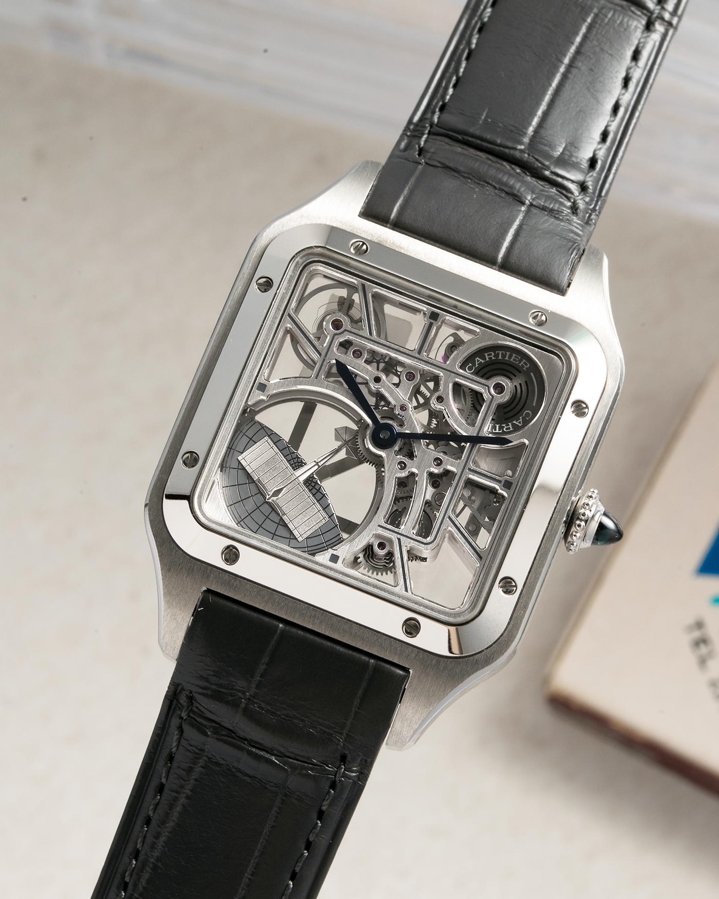 Brand: Cartier Year: 2023 Model: Santos Dumont Skeleton MicroRotor Reference: CRWHSA0032 Material: Stainless Steel Movement: Cartier Cal. 9629 MC, Self-Winding Micro-Rotor Case Diameter: 31.4mm x 43.5mm Strap: Cartier Grey Alligator Leather Strap with Signed Stainless Steel Ardillon Buckle