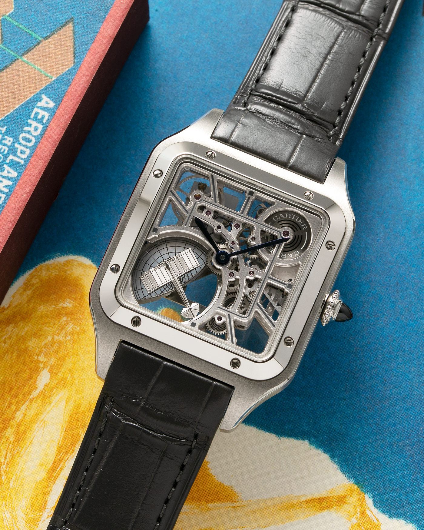 Brand: Cartier Year: 2023 Model: Santos Dumont Skeleton MicroRotor Reference: CRWHSA0032 Material: Stainless Steel Movement: Cartier Cal. 9629 MC, Self-Winding Micro-Rotor Case Diameter: 31.4mm x 43.5mm Strap: Cartier Grey Alligator Leather Strap with Signed Stainless Steel Ardillon Buckle