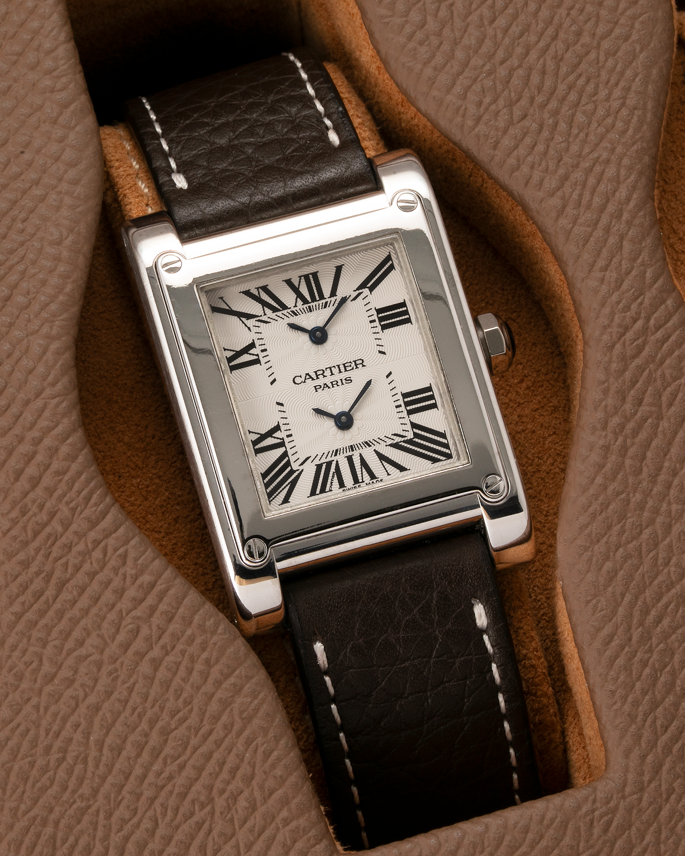 Brand: Cartier Year: 2000s Model: Tank à Vis Dual Time Reference: 2552 Material: 18-carat White Gold Movement: Piaget Ebauche Based Cal. 9901MC, Manual-Winding Case Diameter: 28mm x 32mm Strap: Subdial Dark Brown Textured Calf Leather Strap with Signed 18-carat White Gold Deployant Clasp