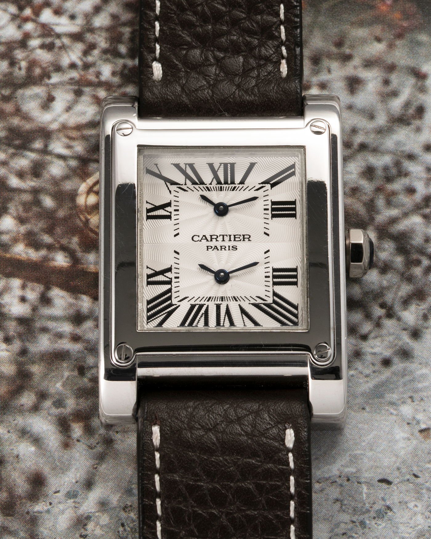 Brand: Cartier Year: 2000s Model: Tank à Vis Dual Time Reference: 2552 Material: 18-carat White Gold Movement: Piaget Ebauche Based Cal. 9901MC, Manual-Winding Case Diameter: 28mm x 32mm Strap: Subdial Dark Brown Textured Calf Leather Strap with Signed 18-carat White Gold Deployant Clasp