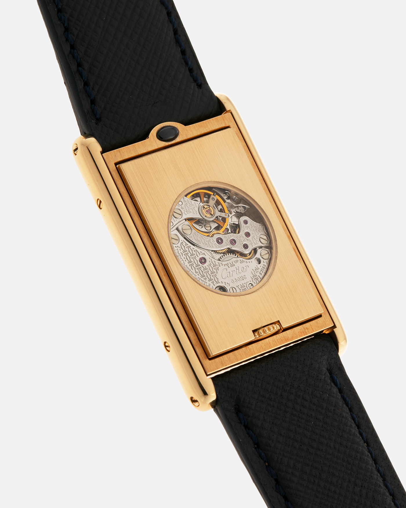 Brand: Cartier Year: 2000s Model: Collection Privée Cartier Paris Tank Basculante Material: 18-carat Yellow Gold Movement: Cartier Cal. 060MC (F. Piguet Cal. 610), Manual-Winding Case Diameter: 25mm x 39mm Lug Width: 20mm Strap: Nostime Navy Textured Calf Leather Strap with Signed 18-carat Yellow Gold Deployant Clasp, additional Cartier Brown Textured Calf Leather Strap (Used)