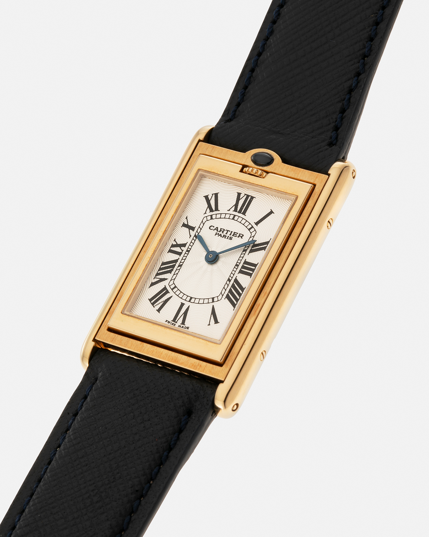 Brand: Cartier Year: 2000s Model: Collection Privée Cartier Paris Tank Basculante Material: 18-carat Yellow Gold Movement: Cartier Cal. 060MC (F. Piguet Cal. 610), Manual-Winding Case Diameter: 25mm x 39mm Lug Width: 20mm Strap: Nostime Navy Textured Calf Leather Strap with Signed 18-carat Yellow Gold Deployant Clasp, additional Cartier Brown Textured Calf Leather Strap (Used)