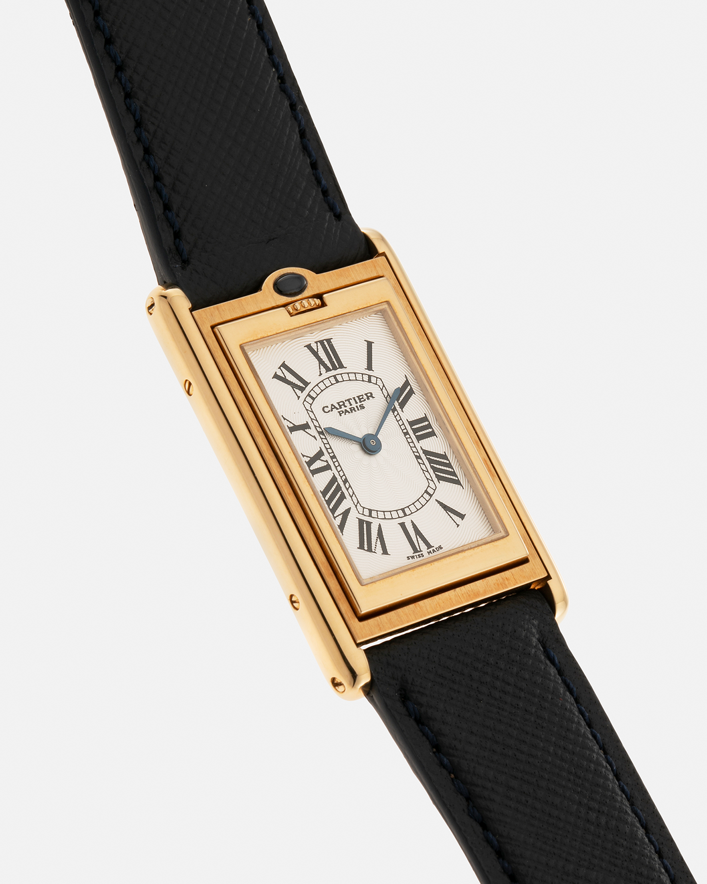 Brand: Cartier Year: 2000s Model: Collection Privée Cartier Paris Tank Basculante Material: 18-carat Yellow Gold Movement: Cartier Cal. 060MC (F. Piguet Cal. 610), Manual-Winding Case Diameter: 25mm x 39mm Lug Width: 20mm Strap: Nostime Navy Textured Calf Leather Strap with Signed 18-carat Yellow Gold Deployant Clasp, additional Cartier Brown Textured Calf Leather Strap (Used)