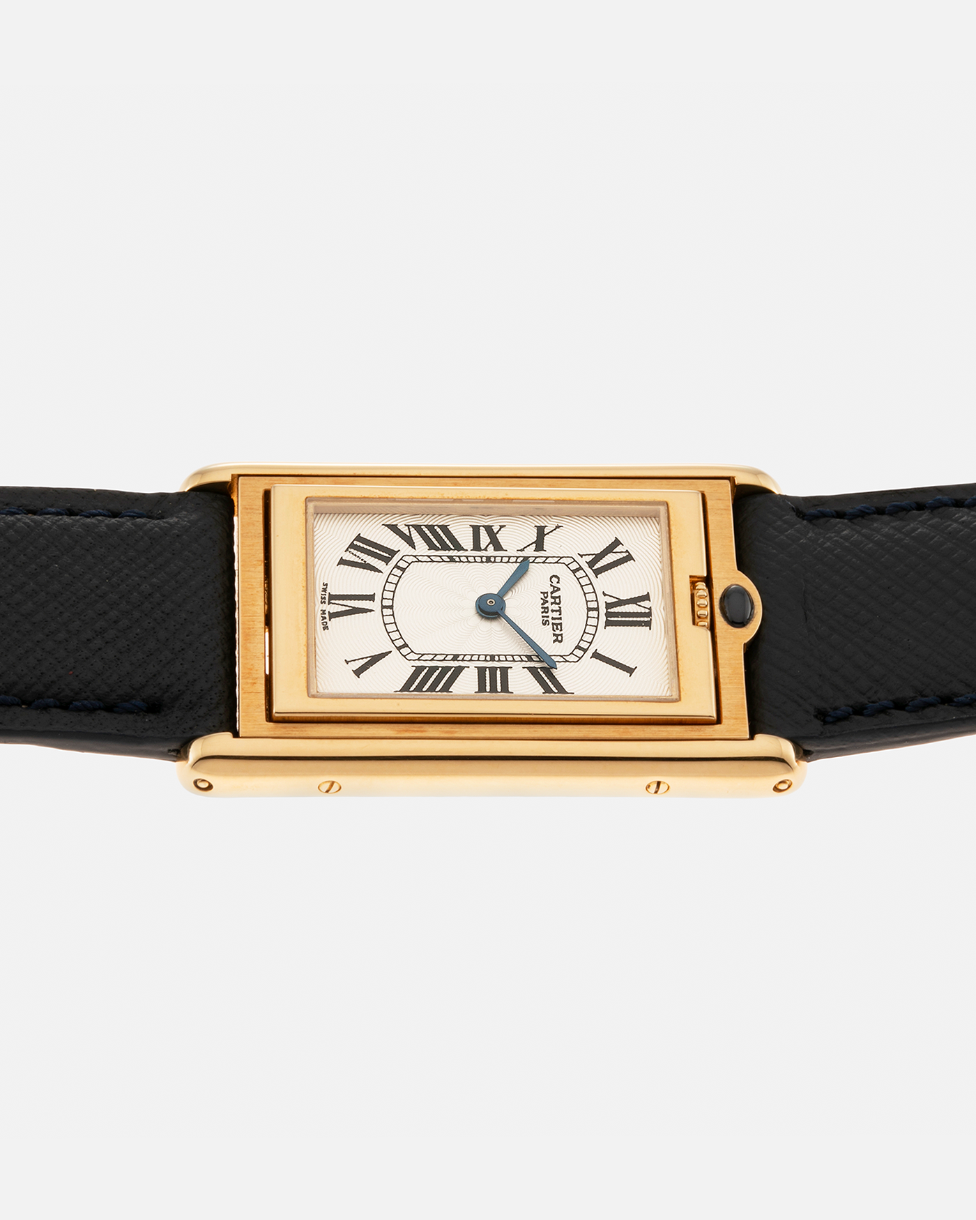 Brand: Cartier Year: 2000s Model: Collection Privée Cartier Paris Tank Basculante Material: 18-carat Yellow Gold Movement: Cartier Cal. 060MC (F. Piguet Cal. 610), Manual-Winding Case Diameter: 25mm x 39mm Lug Width: 20mm Strap: Nostime Navy Textured Calf Leather Strap with Signed 18-carat Yellow Gold Deployant Clasp, additional Cartier Brown Textured Calf Leather Strap (Used)