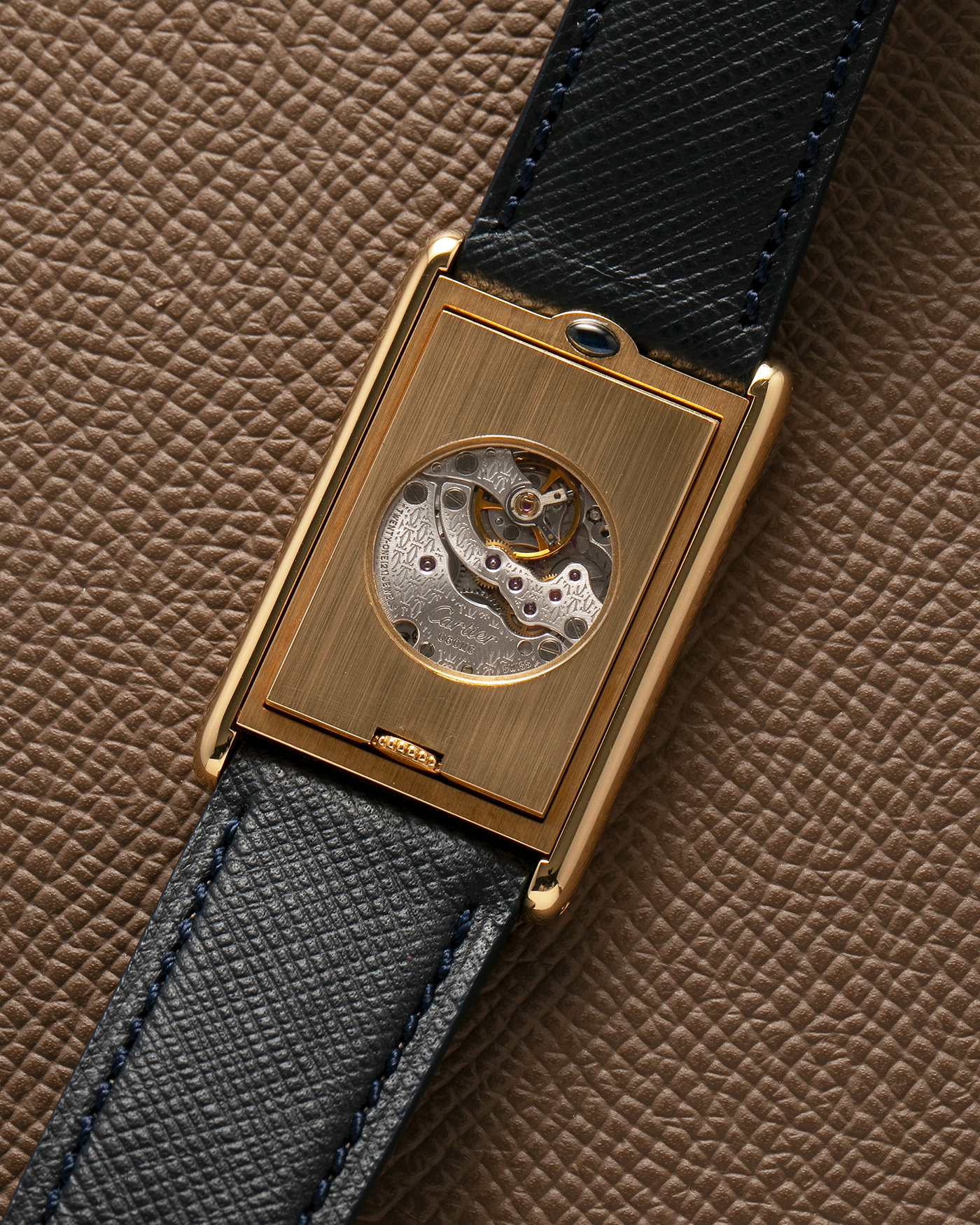 Brand: Cartier Year: 2000s Model: Collection Privée Cartier Paris Tank Basculante Material: 18-carat Yellow Gold Movement: Cartier Cal. 060MC (F. Piguet Cal. 610), Manual-Winding Case Diameter: 25mm x 39mm Lug Width: 20mm Strap: Nostime Navy Textured Calf Leather Strap with Signed 18-carat Yellow Gold Deployant Clasp, additional Cartier Brown Textured Calf Leather Strap (Used)