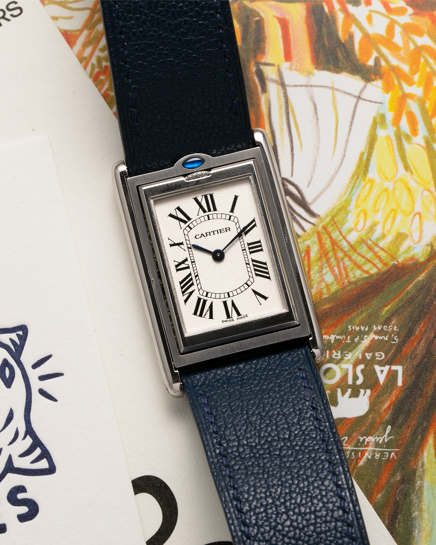 Brand: Cartier Year: 1990’s Model: Tank Basculante Reference: 2390 Material: Stainless Steel Movement: Piguet-derived Cartier Cal. 050 MC, Manual-Winding Case Diameter: 26mm x 38mm Strap: Alexandre Ritz Navy Blue Calf Leather Strap with Signed Stainless Steel Tang Buckle