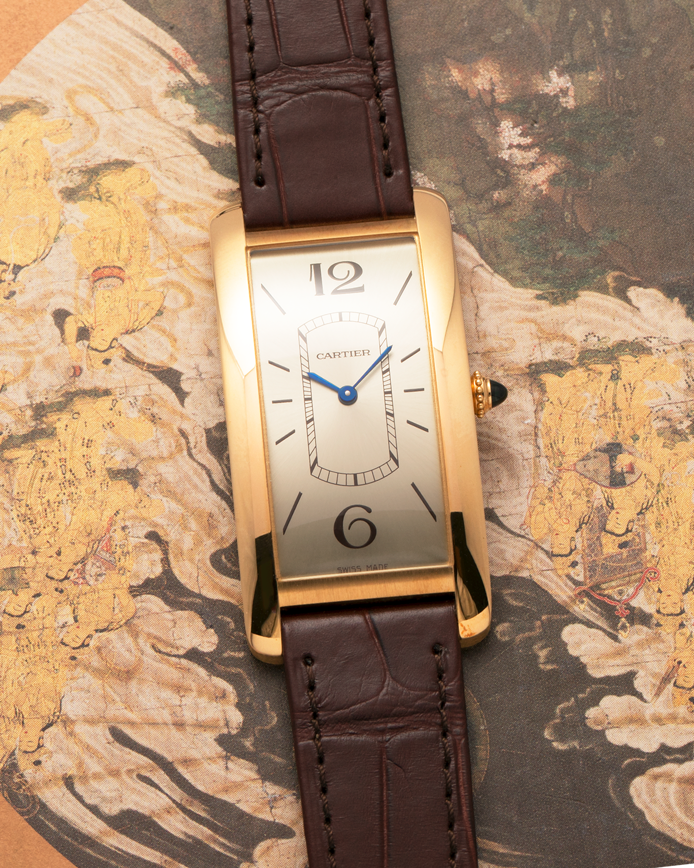 Brand: Cartier
Year: 2022
Model: Tank Cintrée
Reference: WGTA0026, 4123
Material: 18-carat Yellow Gold
Movement: Cartier Cal. 8971 MC (Based on JLC Cal. 846), Manual-Winding
Case Dimensions: 46.3mm (Including Lugs) x 23 mm
Lug Width: 16mm
Strap: Cartier Semi-Matt Brown Alligator Leather Strap with Signed 18-carat Yellow Gold Tang Buckle