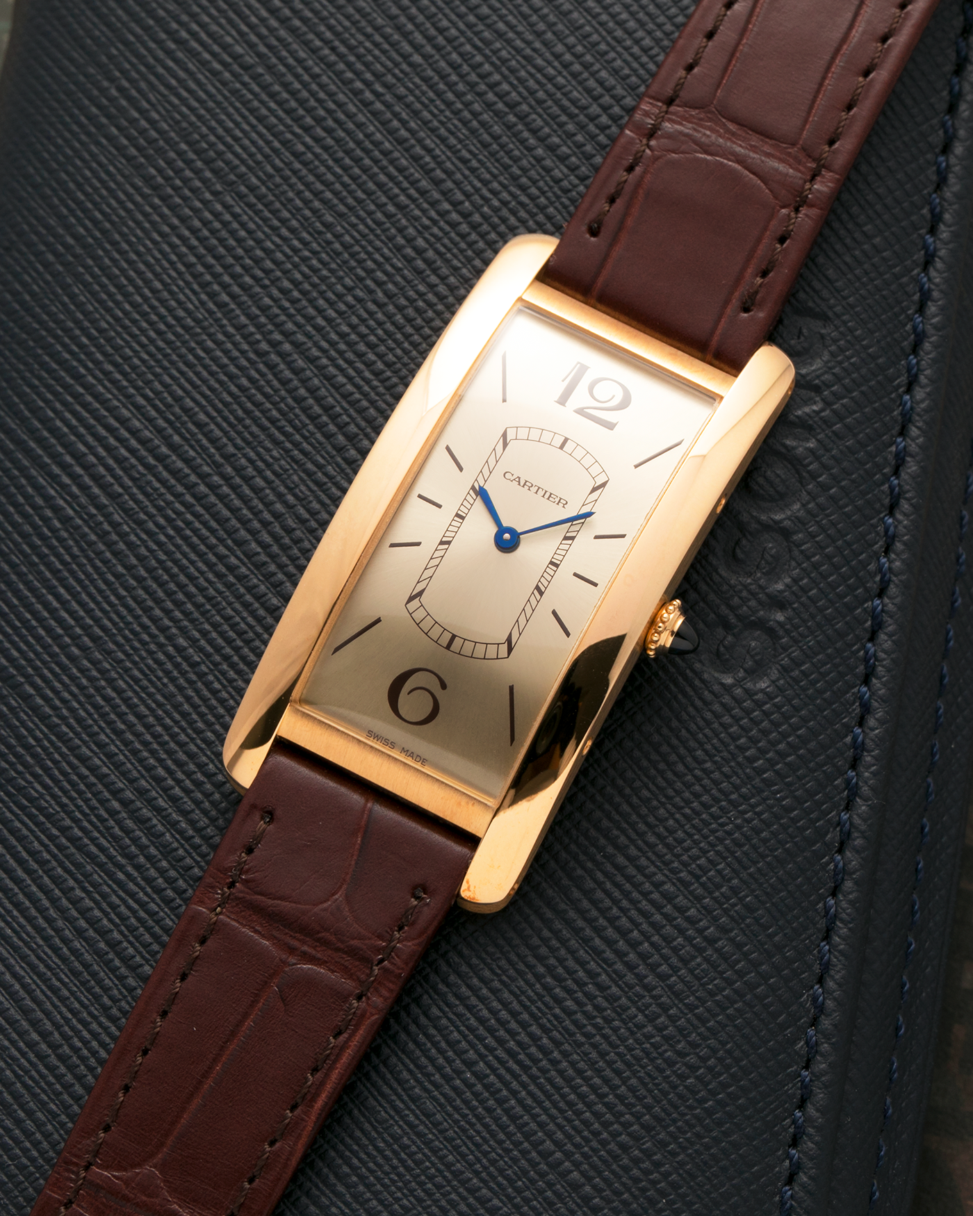 Brand: Cartier
Year: 2022
Model: Tank Cintrée
Reference: WGTA0026, 4123
Material: 18-carat Yellow Gold
Movement: Cartier Cal. 8971 MC (Based on JLC Cal. 846), Manual-Winding
Case Dimensions: 46.3mm (Including Lugs) x 23 mm
Lug Width: 16mm
Strap: Cartier Semi-Matt Brown Alligator Leather Strap with Signed 18-carat Yellow Gold Tang Buckle