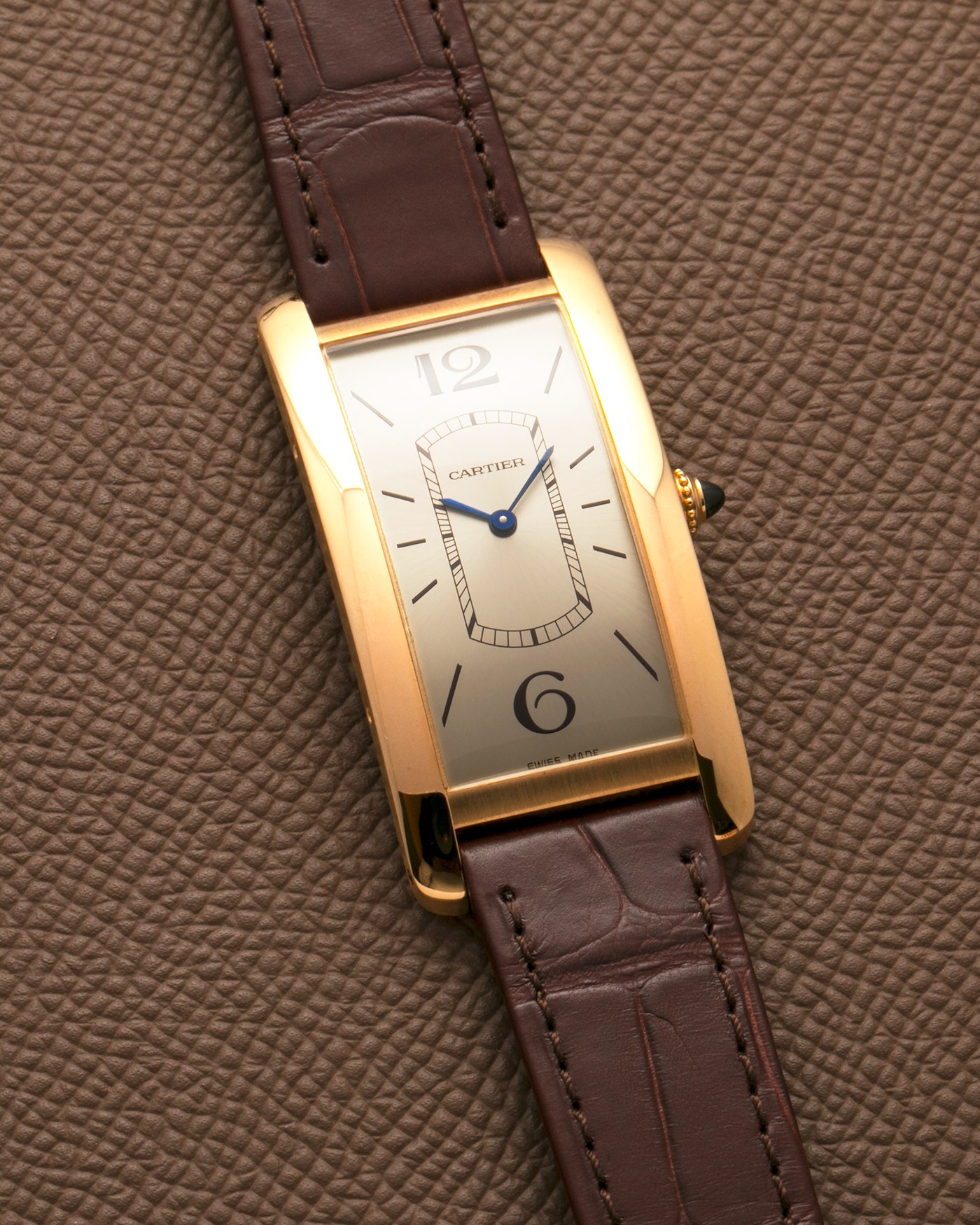 Brand: Cartier
Year: 2022
Model: Tank Cintrée
Reference: WGTA0026, 4123
Material: 18-carat Yellow Gold
Movement: Cartier Cal. 8971 MC (Based on JLC Cal. 846), Manual-Winding
Case Dimensions: 46.3mm (Including Lugs) x 23 mm
Lug Width: 16mm
Strap: Cartier Semi-Matt Brown Alligator Leather Strap with Signed 18-carat Yellow Gold Tang Buckle