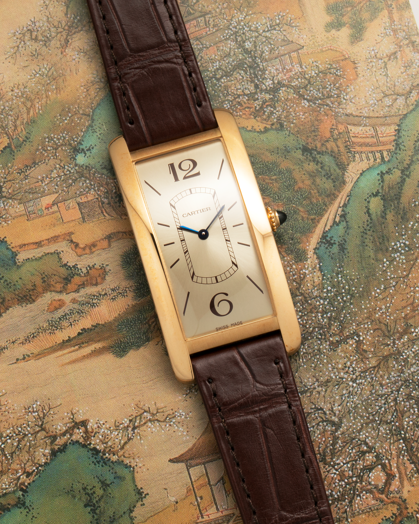 Brand: Cartier
Year: 2022
Model: Tank Cintrée
Reference: WGTA0026, 4123
Material: 18-carat Yellow Gold
Movement: Cartier Cal. 8971 MC (Based on JLC Cal. 846), Manual-Winding
Case Dimensions: 46.3mm (Including Lugs) x 23 mm
Lug Width: 16mm
Strap: Cartier Semi-Matt Brown Alligator Leather Strap with Signed 18-carat Yellow Gold Tang Buckle