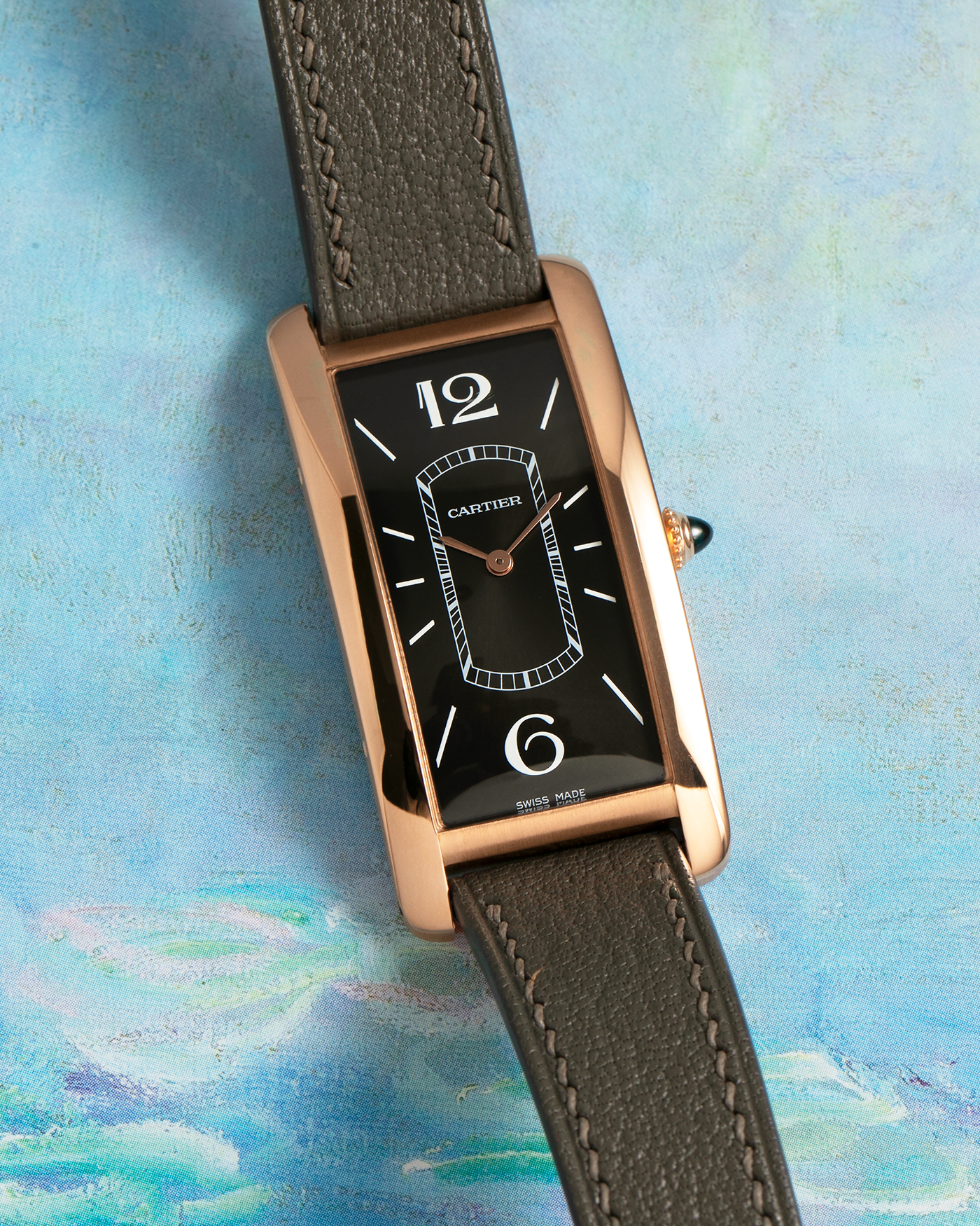 Brand: Cartier Year: 2021 Model: Tank Cintrée Reference: WGTA0025 Material: 18-carat Rose Gold Movement: Cartier Cal. 8971 MC (Based on JLC Cal. 846), Manual-Winding Case Diameter: 46.3mm x 23 mm Lug Width: 16mm Strap: Semi-Matt Grey Leather Strap with Signed 18-carat Rose Gold Tang Buckle