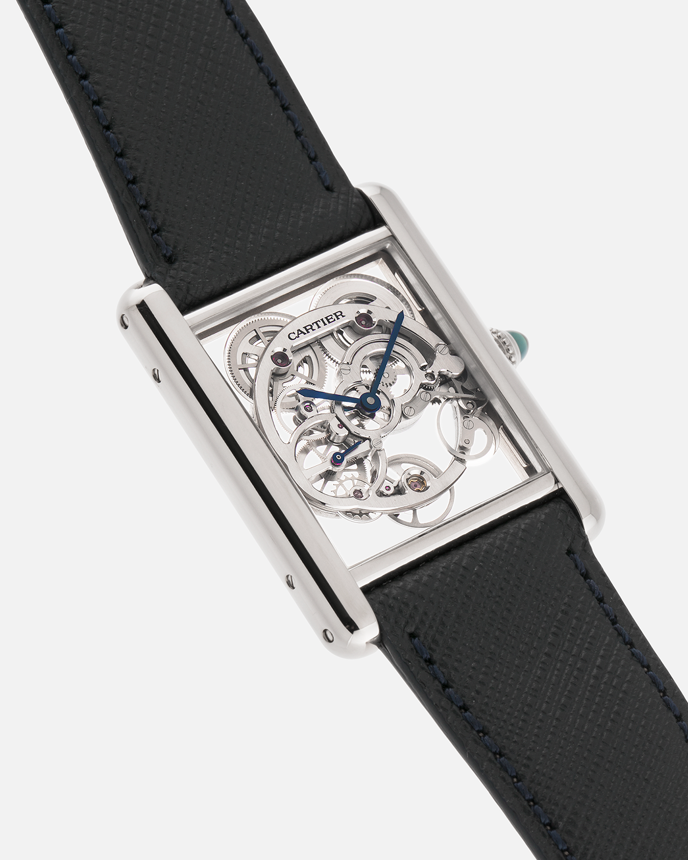 Brand: Cartier
Year: 2015
Model: Tank Louis Cartier Sapphire Skeleton
Reference: W5310012
Material: 18k White Gold
Movement: Manual-Winding Cartier Calibre 9616 MC
Case Dimensions: 39.2mm by 30mm, 7.45mm Thickness
Strap: Navy Blue Molequin Textured Calf Strap, Grey Blue Cartier Alligator Strap, Sealed Black Cartier Alligator Strap with 18k White Gold Cartier Deployant Buckle