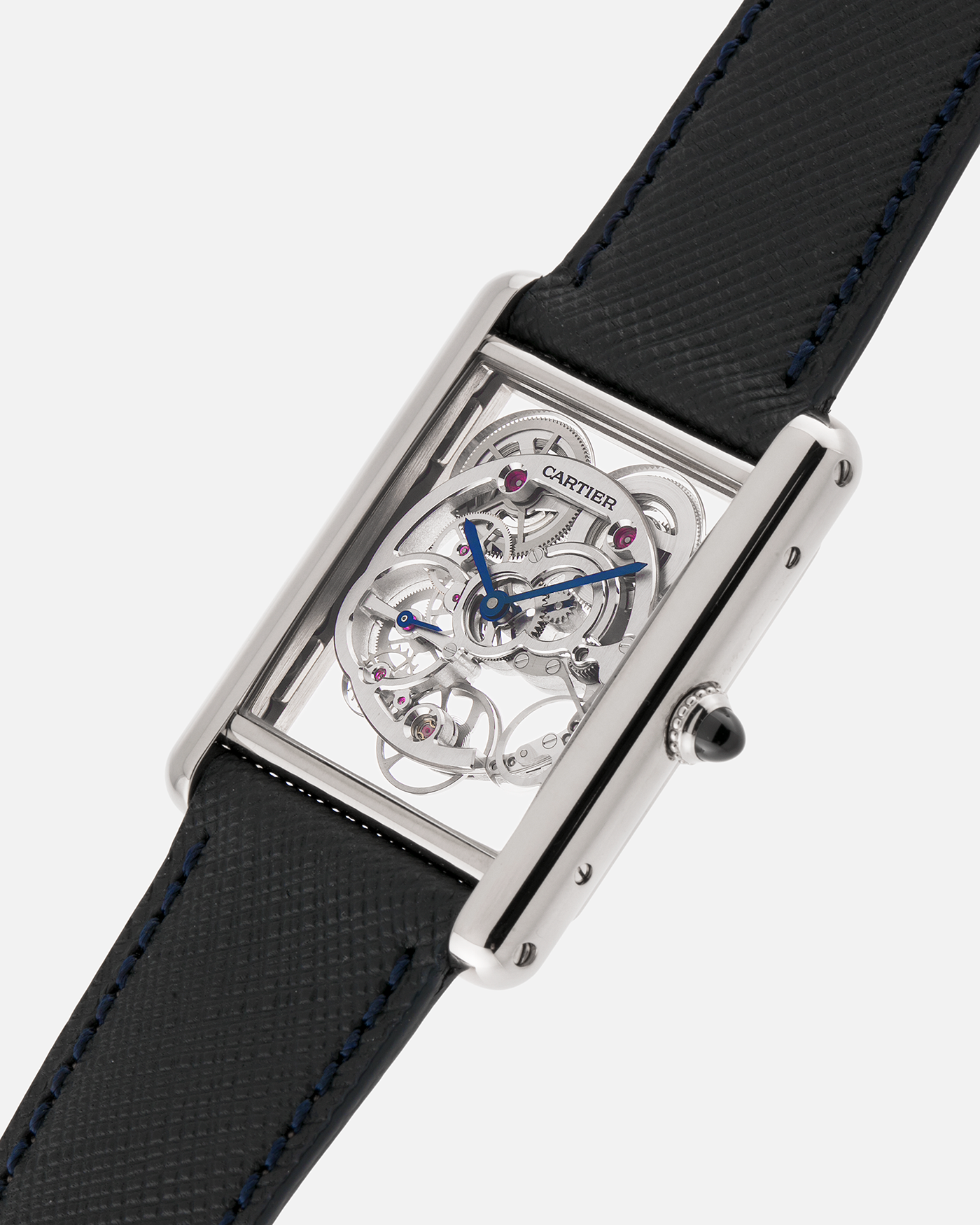 Brand: Cartier
Year: 2015
Model: Tank Louis Cartier Sapphire Skeleton
Reference: W5310012
Material: 18k White Gold
Movement: Manual-Winding Cartier Calibre 9616 MC
Case Dimensions: 39.2mm by 30mm, 7.45mm Thickness
Strap: Navy Blue Molequin Textured Calf Strap, Grey Blue Cartier Alligator Strap, Sealed Black Cartier Alligator Strap with 18k White Gold Cartier Deployant Buckle