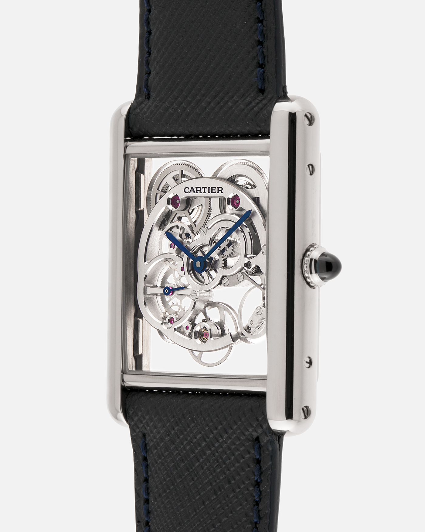 Brand: Cartier
Year: 2015
Model: Tank Louis Cartier Sapphire Skeleton
Reference: W5310012
Material: 18k White Gold
Movement: Manual-Winding Cartier Calibre 9616 MC
Case Dimensions: 39.2mm by 30mm, 7.45mm Thickness
Strap: Navy Blue Molequin Textured Calf Strap, Grey Blue Cartier Alligator Strap, Sealed Black Cartier Alligator Strap with 18k White Gold Cartier Deployant Buckle