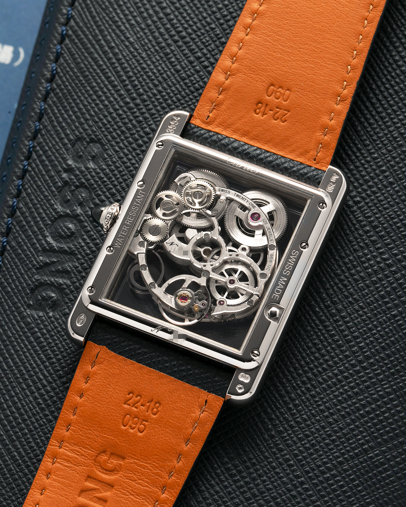 Brand: Cartier
Year: 2015
Model: Tank Louis Cartier Sapphire Skeleton
Reference: W5310012
Material: 18k White Gold
Movement: Manual-Winding Cartier Calibre 9616 MC
Case Dimensions: 39.2mm by 30mm, 7.45mm Thickness
Strap: Navy Blue Molequin Textured Calf Strap, Grey Blue Cartier Alligator Strap, Sealed Black Cartier Alligator Strap with 18k White Gold Cartier Deployant Buckle