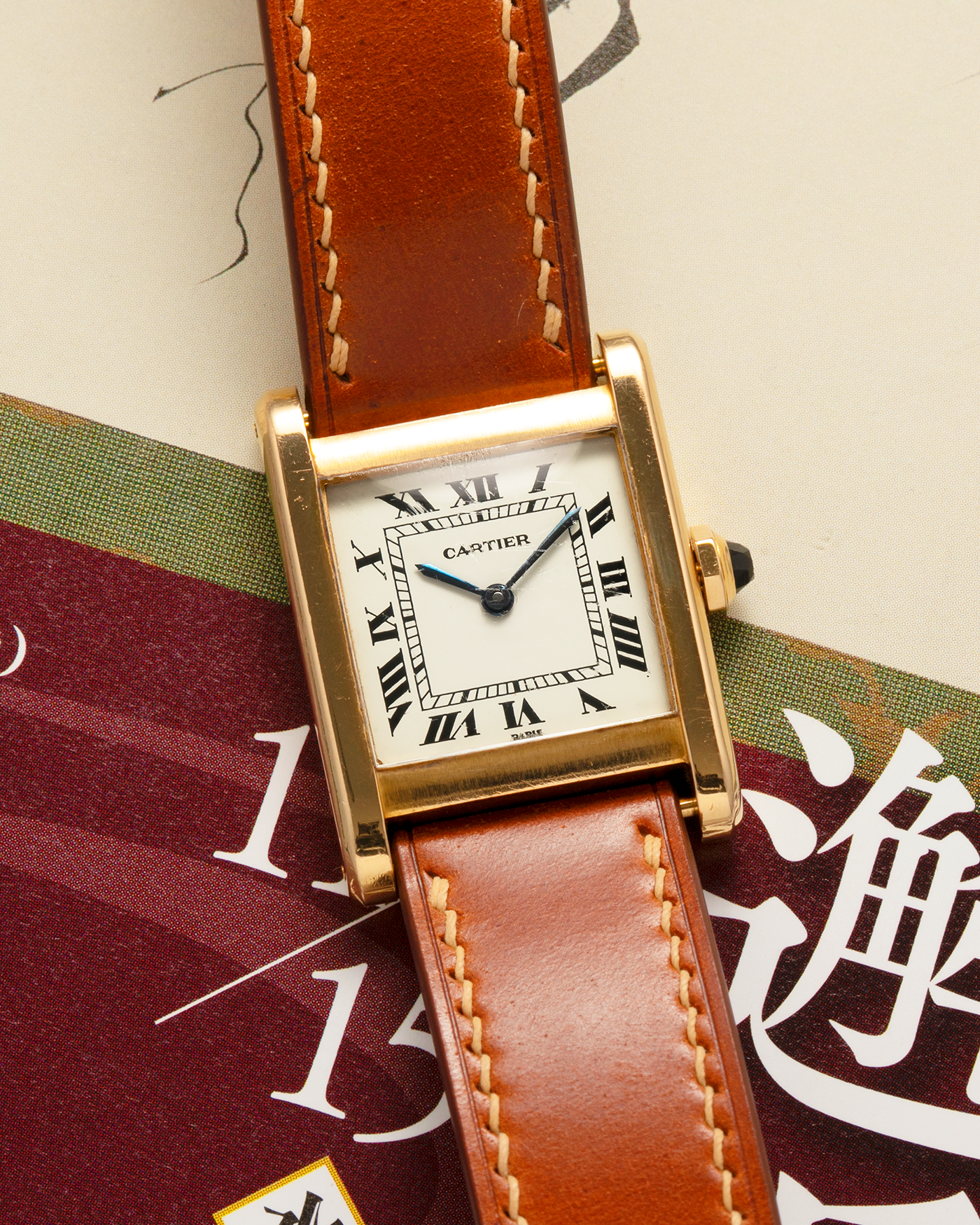 Brand: Cartier
Year: 1976
Model: Tank Normale
Reference Number: 78092
Material: 18-carat Yellow Gold
Movement: Cartier Cal. 78-1, Manual-Winding
Case Diameter: 30mm (Lug-to-Lug) x 22mm x 6.6mm
Lug Width: 17mm
Strap: Custom Tanned Brown Calf Leather Strap with Signed 18-carat Yellow Gold ‘London’ Deployant Clasp