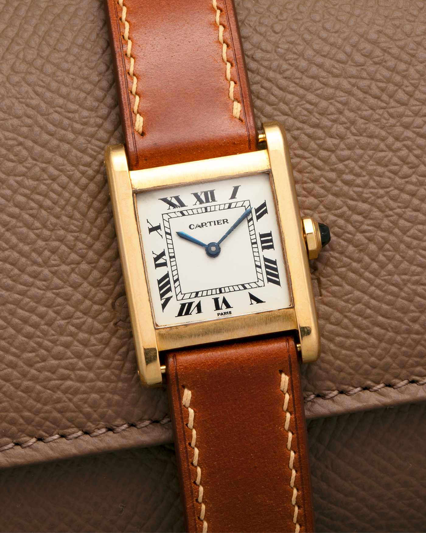 Brand: Cartier
Year: 1976
Model: Tank Normale
Reference Number: 78092
Material: 18-carat Yellow Gold
Movement: Cartier Cal. 78-1, Manual-Winding
Case Diameter: 30mm (Lug-to-Lug) x 22mm x 6.6mm
Lug Width: 17mm
Strap: Custom Tanned Brown Calf Leather Strap with Signed 18-carat Yellow Gold ‘London’ Deployant Clasp
