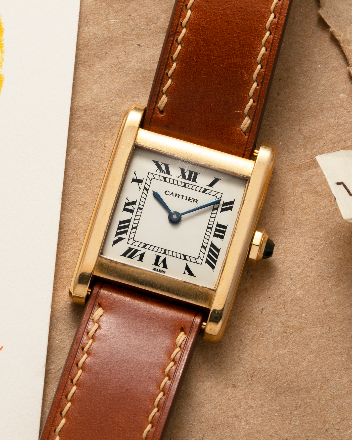 Brand: Cartier
Year: 1976
Model: Tank Normale
Reference Number: 78092
Material: 18-carat Yellow Gold
Movement: Cartier Cal. 78-1, Manual-Winding
Case Diameter: 30mm (Lug-to-Lug) x 22mm x 6.6mm
Lug Width: 17mm
Strap: Custom Tanned Brown Calf Leather Strap with Signed 18-carat Yellow Gold ‘London’ Deployant Clasp