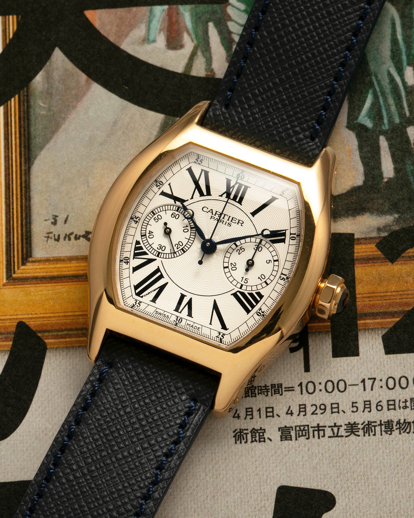 Brand: Cartier
Year: 2008
Model: Collection Privée Cartier Paris Tortue Monopoussoir
Reference: 2356
Material: 18-carat Yellow Gold
Movement: Cartier THA Cal. 045MC, Manual-Winding
Case Diameter: 43mm (Lug-to-Lug) x 35 mm
Lug Width: 18mm
Strap: Molequin Navy Blue Textured Calf Leather with Signed 18-carat Yellow Gold Deployant Clasp, with additional Cartier Green Alligator Leather Strap