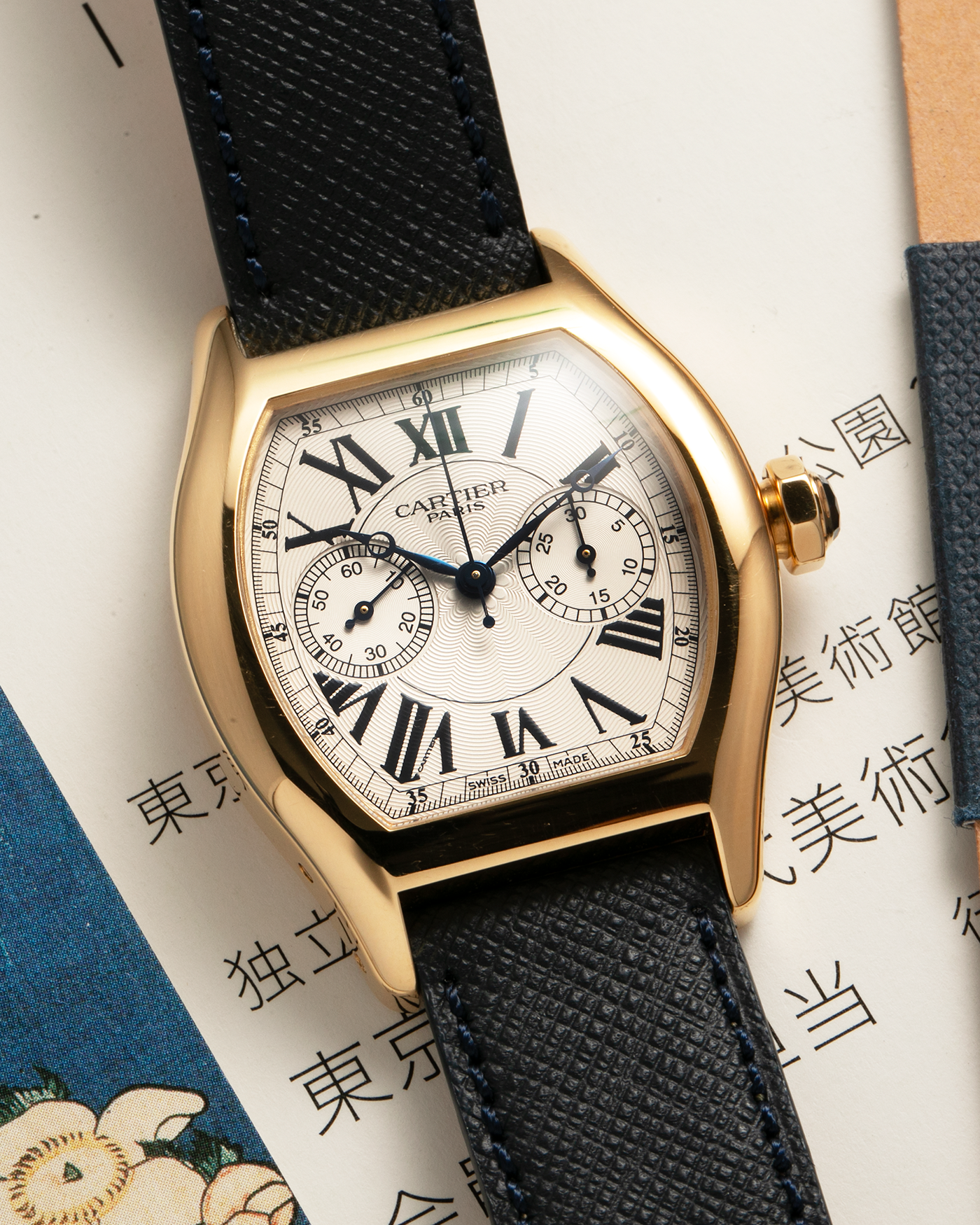 Brand: Cartier Year: 2000’s Model: Collection Privée Cartier Paris Tortue Monopoussoir Reference: 2356E Material: 18-carat Yellow Gold Movement: Cartier THA Cal. 045MC, Manual-Winding Case Diameter: 43mm x 35 mm Lug Width: 18mm Strap: Molequin Navy Blue Textured Calf Leather with Signed 18-carat Yellow Gold Deployant Clasp
