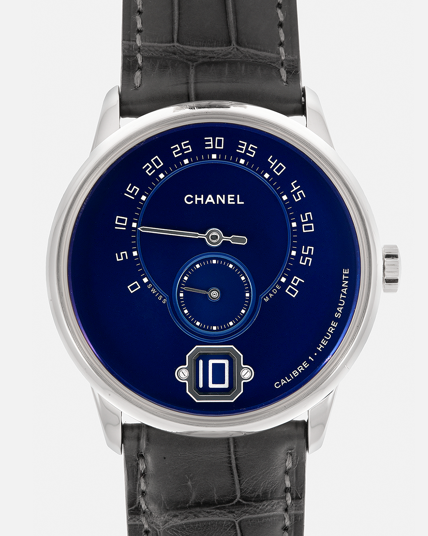 Brand: Chanel
Year: 2018
Model: Monsieur De Chanel Jump Hour, Limited to 20 Pieces
Reference: H5467
Material: Platinum 950 Case and Deployant Clasp, Blue Enamel Dial
Movement: Chanel Calibre 1 (Developed with Romain Gauthier), Manual-Winding 
Case Dimensions: 40mm x 10.4mm
Lug Width: 22mm
Straps: Chanel Grey Alligator Leather Strap with Signed Platinum 950 Deployant Clasp, with extra Chanel Black Alligator Leather Strap (Used)