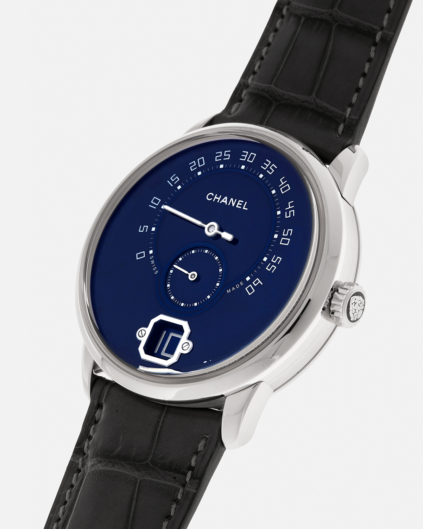 Brand: Chanel
Year: 2018
Model: Monsieur De Chanel Jump Hour, Limited to 20 Pieces
Reference: H5467
Material: Platinum 950 Case and Deployant Clasp, Blue Enamel Dial
Movement: Chanel Calibre 1 (Developed with Romain Gauthier), Manual-Winding 
Case Dimensions: 40mm x 10.4mm
Lug Width: 22mm
Straps: Chanel Grey Alligator Leather Strap with Signed Platinum 950 Deployant Clasp, with extra Chanel Black Alligator Leather Strap (Used)