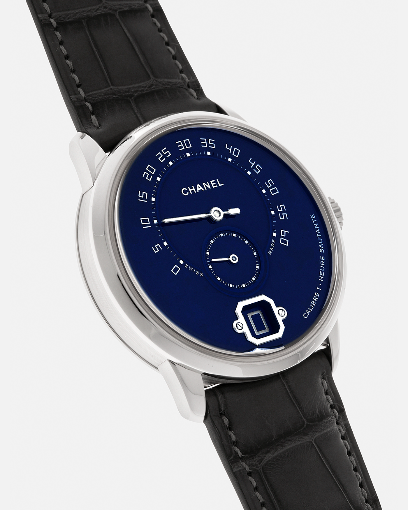 Brand: Chanel
Year: 2018
Model: Monsieur De Chanel Jump Hour, Limited to 20 Pieces
Reference: H5467
Material: Platinum 950 Case and Deployant Clasp, Blue Enamel Dial
Movement: Chanel Calibre 1 (Developed with Romain Gauthier), Manual-Winding 
Case Dimensions: 40mm x 10.4mm
Lug Width: 22mm
Straps: Chanel Grey Alligator Leather Strap with Signed Platinum 950 Deployant Clasp, with extra Chanel Black Alligator Leather Strap (Used)