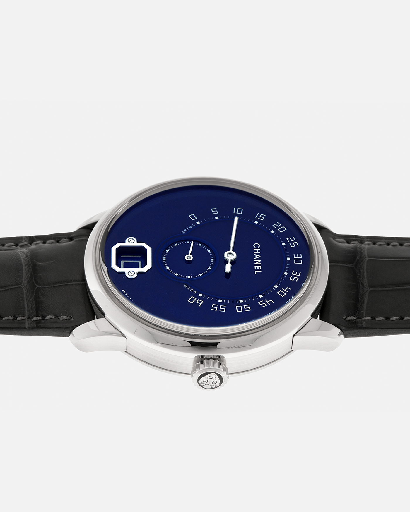 Brand: Chanel
Year: 2018
Model: Monsieur De Chanel Jump Hour, Limited to 20 Pieces
Reference: H5467
Material: Platinum 950 Case and Deployant Clasp, Blue Enamel Dial
Movement: Chanel Calibre 1 (Developed with Romain Gauthier), Manual-Winding 
Case Dimensions: 40mm x 10.4mm
Lug Width: 22mm
Straps: Chanel Grey Alligator Leather Strap with Signed Platinum 950 Deployant Clasp, with extra Chanel Black Alligator Leather Strap (Used)