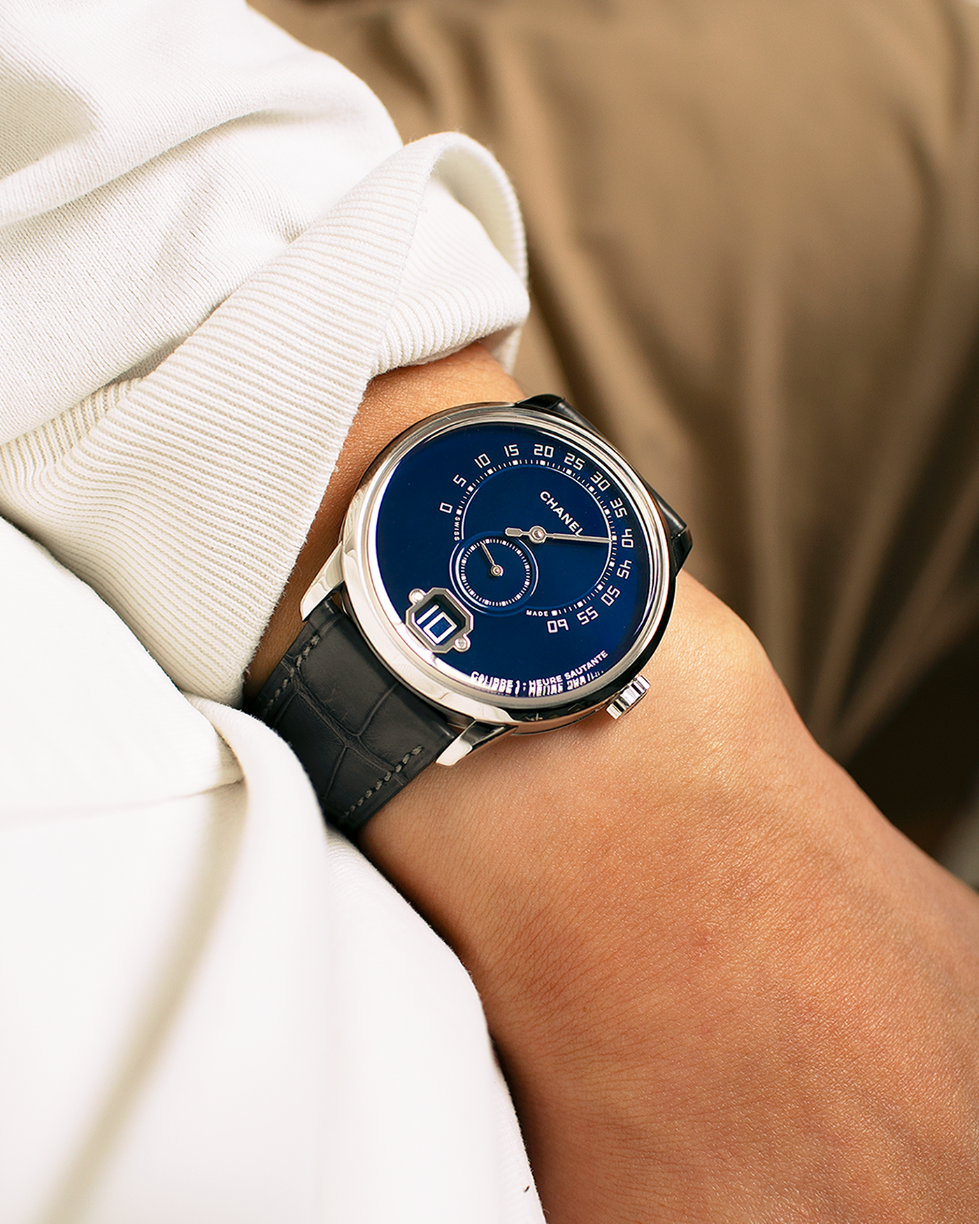 Brand: Chanel
Year: 2018
Model: Monsieur De Chanel Jump Hour, Limited to 20 Pieces
Reference: H5467
Material: Platinum 950 Case and Deployant Clasp, Blue Enamel Dial
Movement: Chanel Calibre 1 (Developed with Romain Gauthier), Manual-Winding 
Case Dimensions: 40mm x 10.4mm
Lug Width: 22mm
Straps: Chanel Grey Alligator Leather Strap with Signed Platinum 950 Deployant Clasp, with extra Chanel Black Alligator Leather Strap (Used)