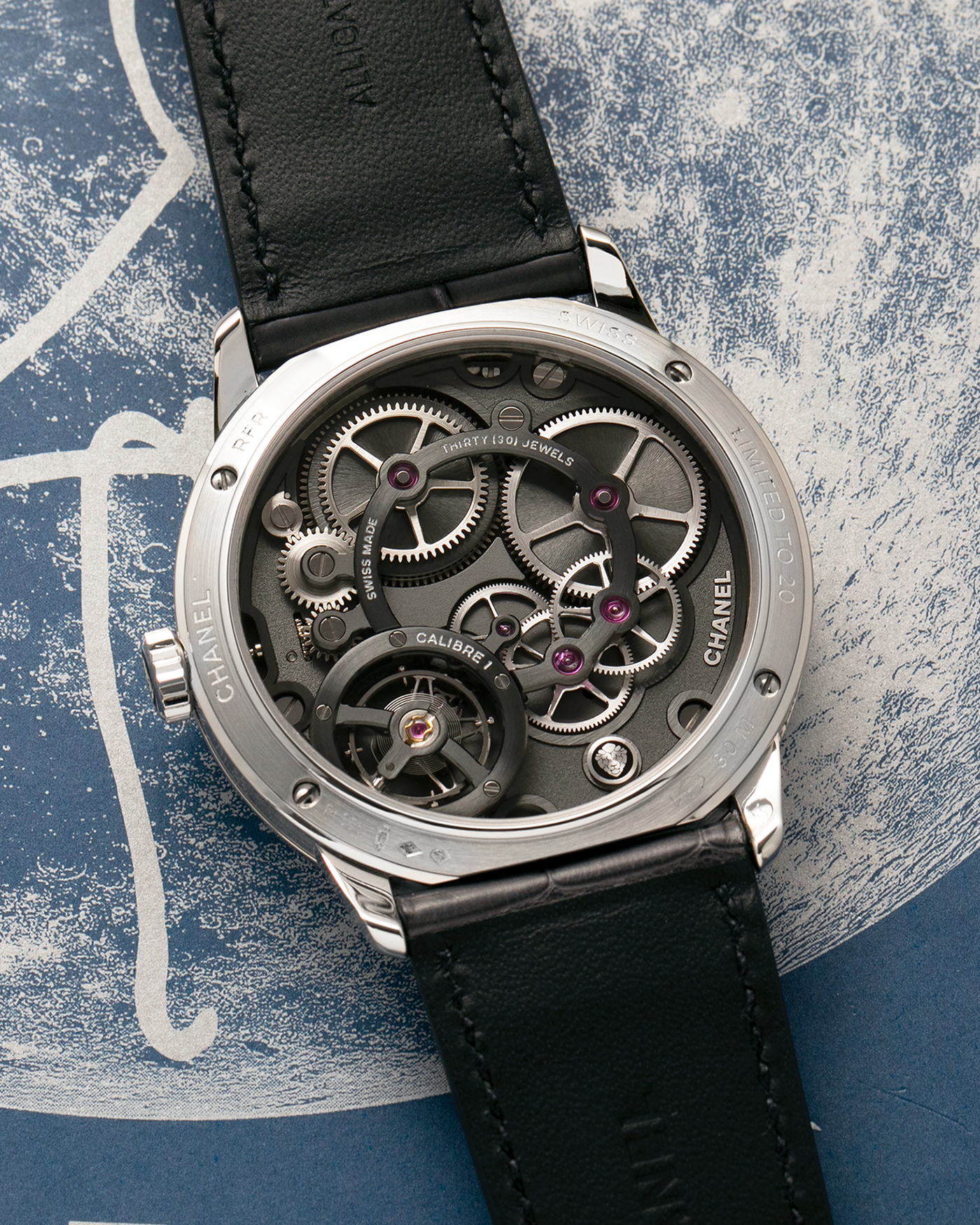 Brand: Chanel
Year: 2018
Model: Monsieur De Chanel Jump Hour, Limited to 20 Pieces
Reference: H5467
Material: Platinum 950 Case and Deployant Clasp, Blue Enamel Dial
Movement: Chanel Calibre 1 (Developed with Romain Gauthier), Manual-Winding 
Case Dimensions: 40mm x 10.4mm
Lug Width: 22mm
Straps: Chanel Grey Alligator Leather Strap with Signed Platinum 950 Deployant Clasp, with extra Chanel Black Alligator Leather Strap (Used)