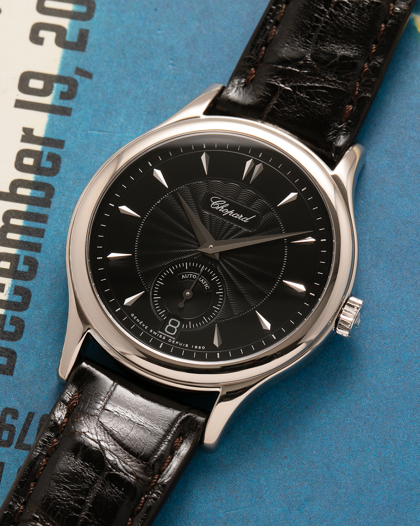 Brand: Chopard L.U.C.
Year: 1998
Model: 16/1860/2
Material: 18-carat White Gold
Movement: Chopard Cal. 1.96, Self-Winding Micro-Rotor
Case Dimensions: 37mm x 8.5mm (Lug-to-Lug 45mm)
Lug Width: 18mm
Strap: Chopard Black Alligator Leather Strap with Signed 18-carat White Gold Tang Buckle