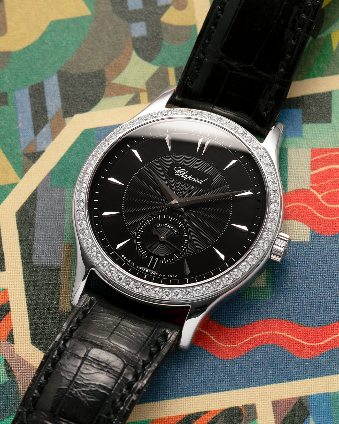 Brand: Chopard L.U.C.
Year: Late 1990s
Model: 17/1860/2
Material: 18-carat White Gold Case, Factory-Set Diamond Bezel
Movement: Chopard Cal. 1.96, Self-Winding Micro-Rotor
Case Dimensions: 37mm x 8.5mm (Lug-to-Lug 45mm)
Lug Width: 18mm
Strap: Chopard Black Alligator Leather Strap with Signed 18-carat White Gold Tang Buckle