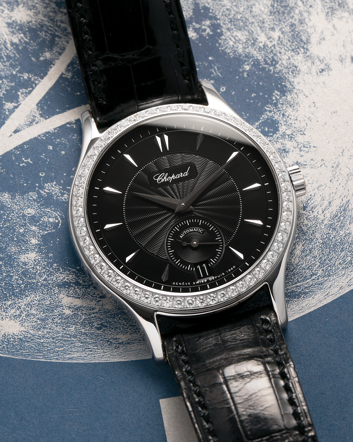Brand: Chopard L.U.C.
Year: Late 1990s
Model: 17/1860/2
Material: 18-carat White Gold Case, Factory-Set Diamond Bezel
Movement: Chopard Cal. 1.96, Self-Winding Micro-Rotor
Case Dimensions: 37mm x 8.5mm (Lug-to-Lug 45mm)
Lug Width: 18mm
Strap: Chopard Black Alligator Leather Strap with Signed 18-carat White Gold Tang Buckle