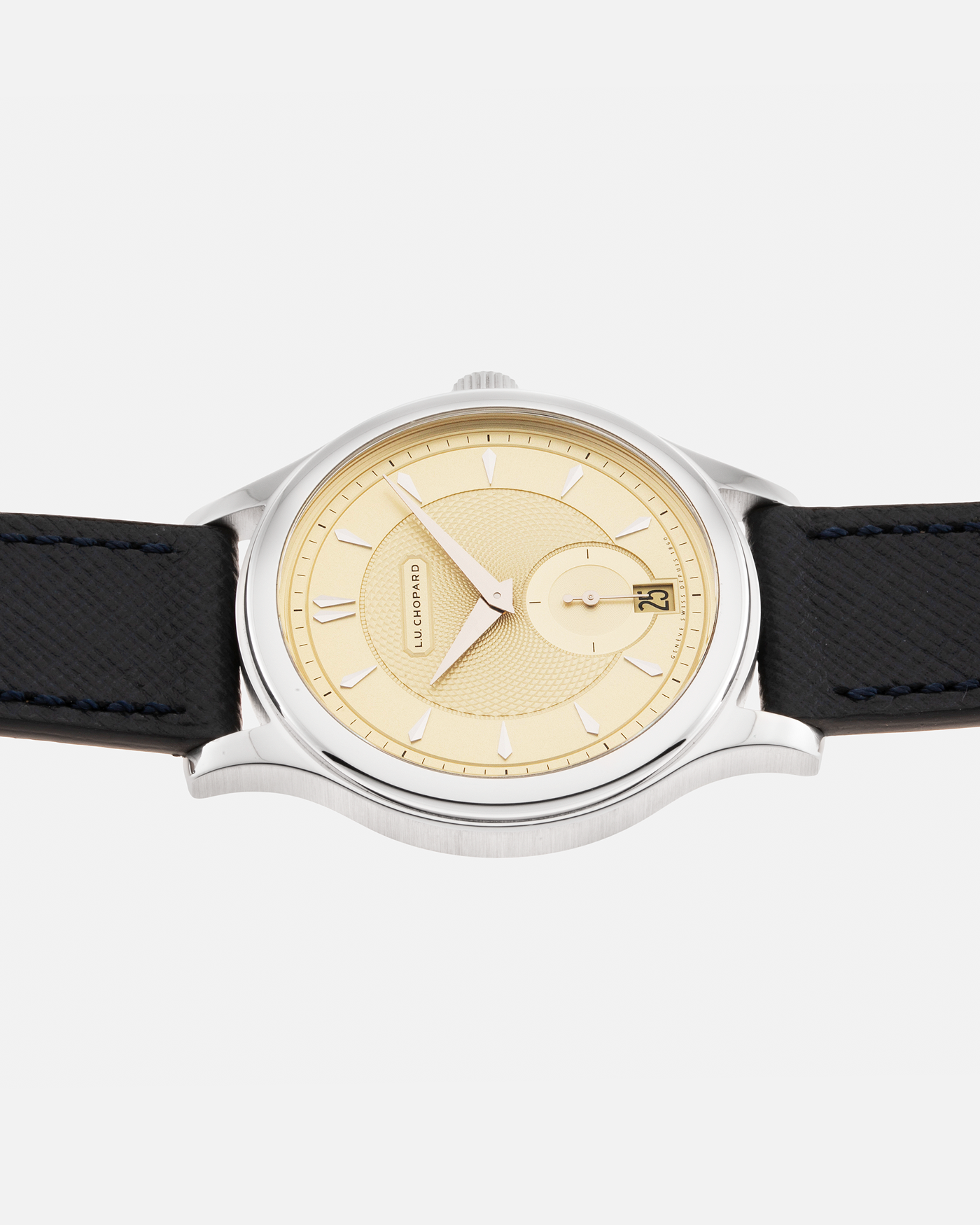 Brand: Chopard L.U.C. Year: 2022 Model / Reference: 16/1860/10018, The Hour Glass Limited Edition of 10 Pieces Serial Number: 425XXXX Material: 18-carat White Gold, Champagne Gold Dial Movement: Chopard Cal. L.U.C. 96.01-L, Self-Winding Case Diameter: 37mm Lug Width: 18mm Strap: Molequin Navy Blue Textured Calf Leather Strap with Signed 18-carat White Gold Tang buckle, and additional Chopard Distressed Sand Leather Strap