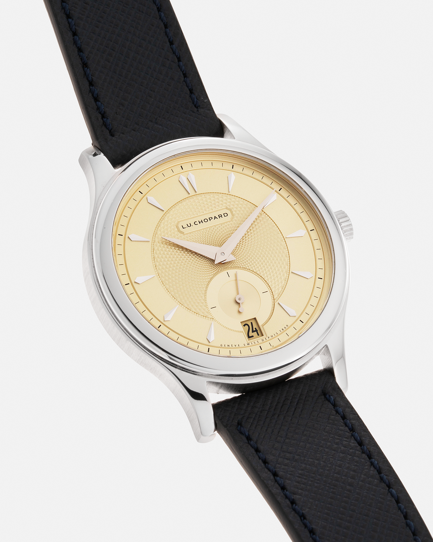 Brand: Chopard L.U.C. Year: 2022 Model / Reference: 16/1860/10018, The Hour Glass Limited Edition of 10 Pieces Serial Number: 425XXXX Material: 18-carat White Gold, Champagne Gold Dial Movement: Chopard Cal. L.U.C. 96.01-L, Self-Winding Case Diameter: 37mm Lug Width: 18mm Strap: Molequin Navy Blue Textured Calf Leather Strap with Signed 18-carat White Gold Tang buckle, and additional Chopard Distressed Sand Leather Strap