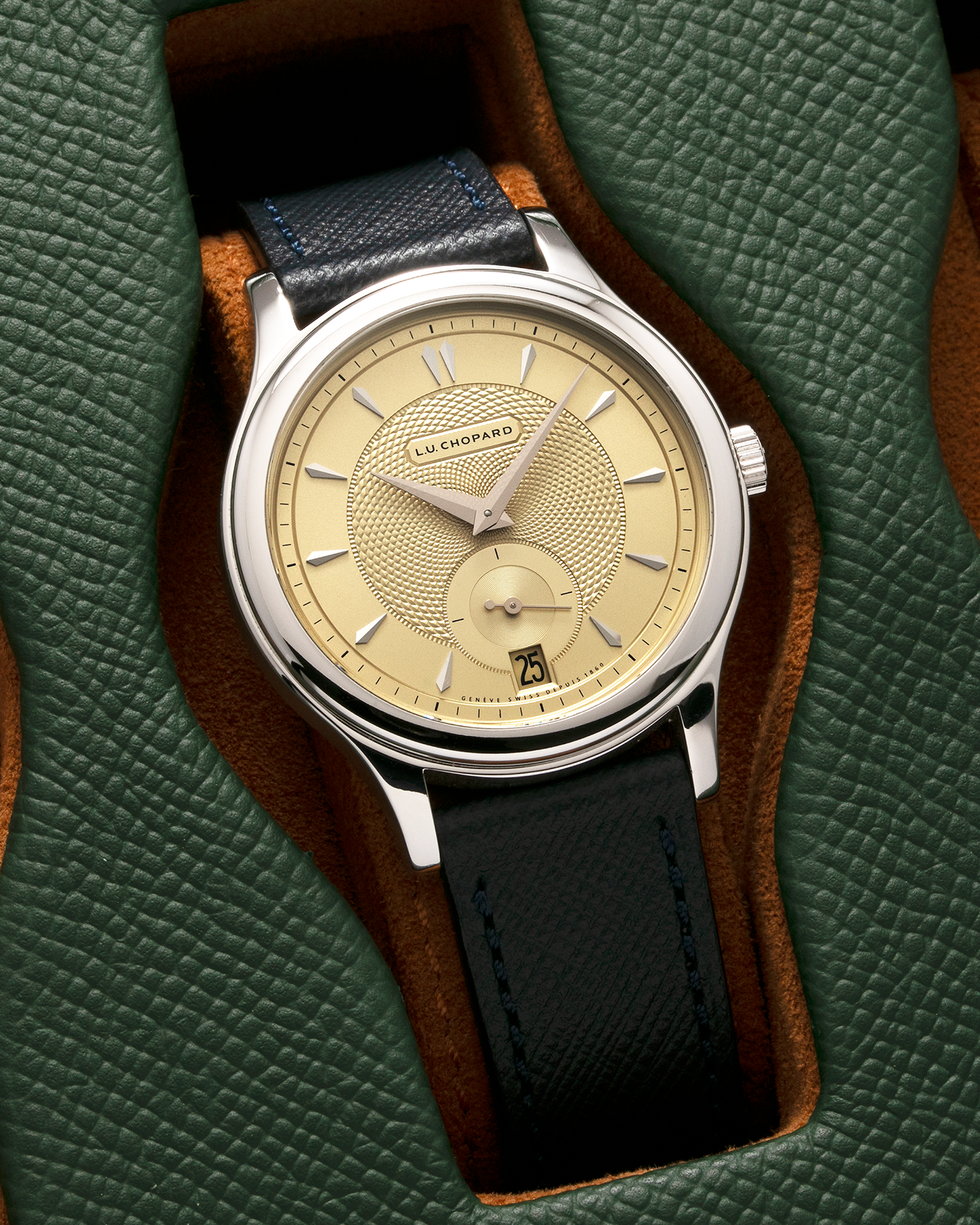 Brand: Chopard L.U.C. Year: 2022 Model / Reference: 16/1860/10018, The Hour Glass Limited Edition of 10 Pieces Serial Number: 425XXXX Material: 18-carat White Gold, Champagne Gold Dial Movement: Chopard Cal. L.U.C. 96.01-L, Self-Winding Case Diameter: 37mm Lug Width: 18mm Strap: Molequin Navy Blue Textured Calf Leather Strap with Signed 18-carat White Gold Tang buckle, and additional Chopard Distressed Sand Leather Strap